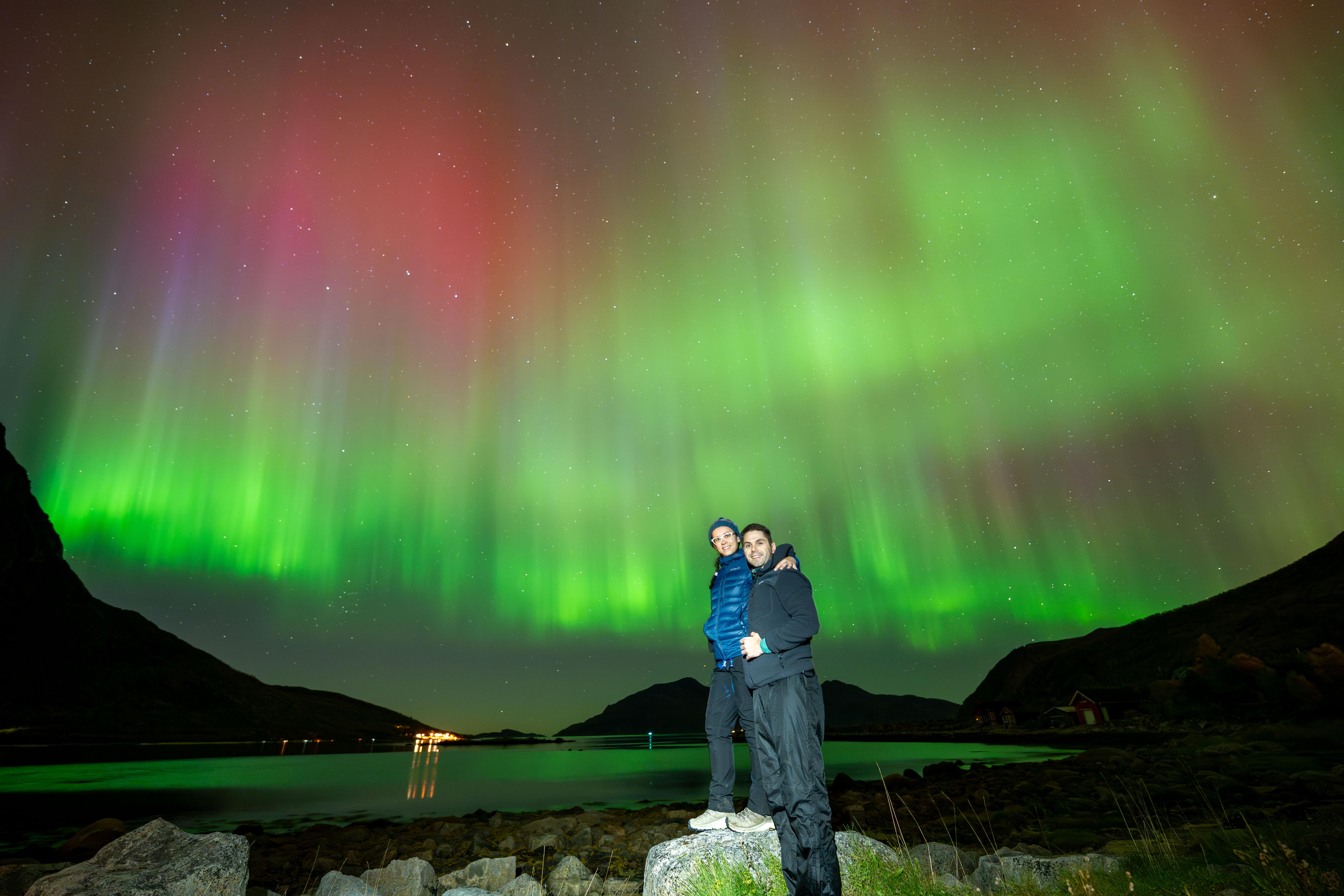 Campfire in Arctic wilderness with Northern Lights overhead on Tromsø tour