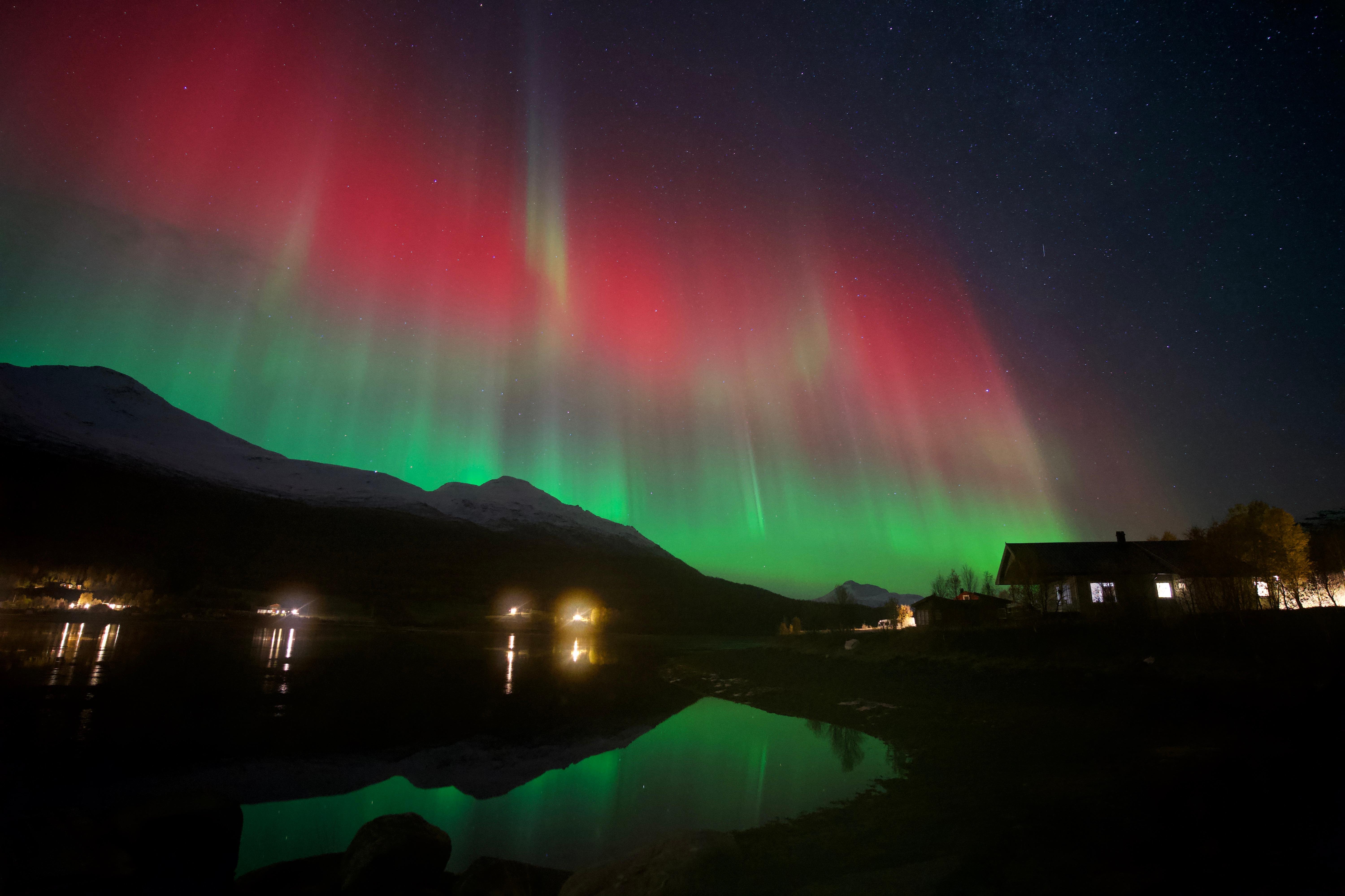 Small group minibus parked under the aurora with guide and 15 guests
