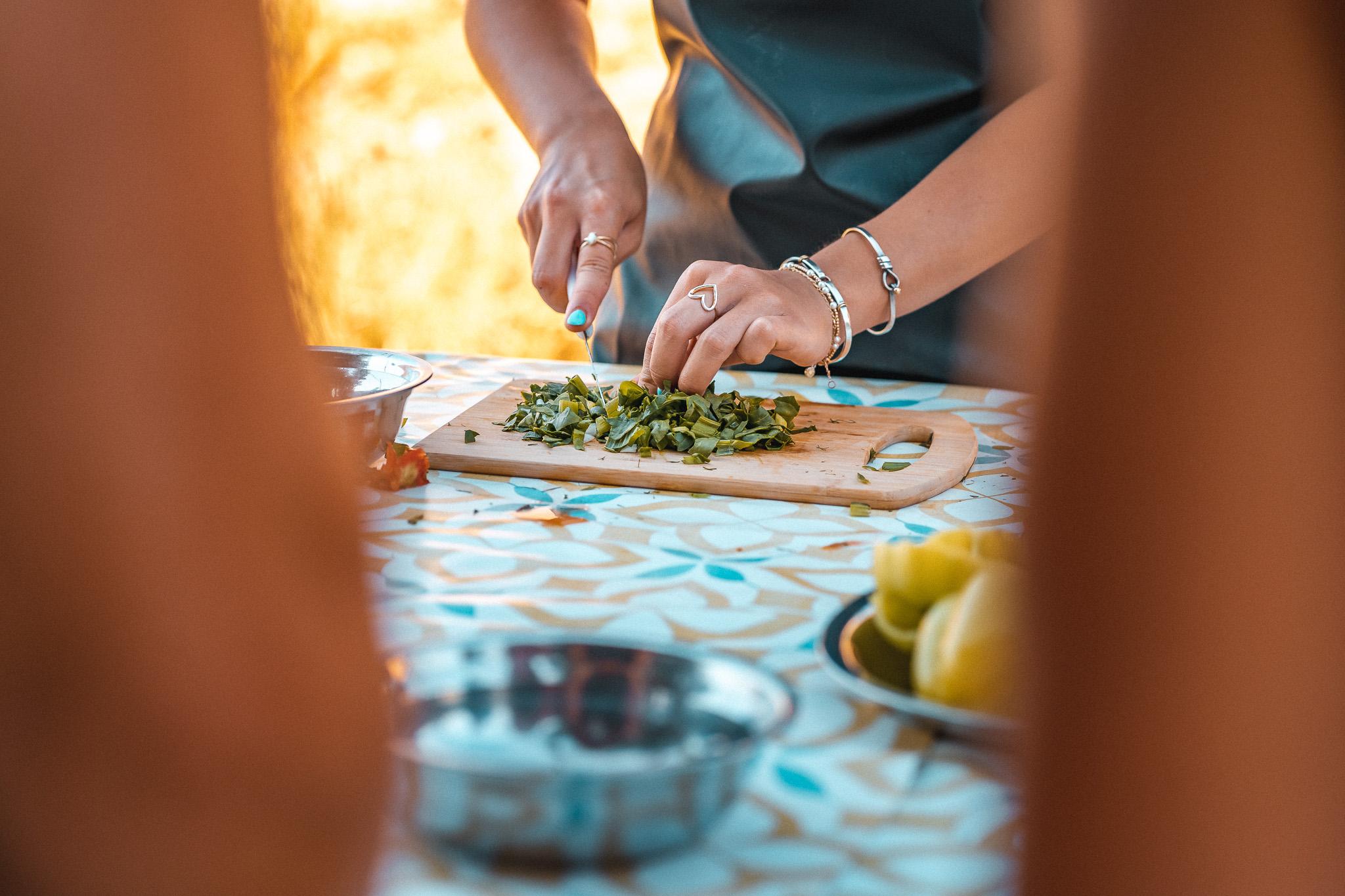 Folding kalitsounia Cretan cheese pies by hand during a Chania cooking class, Crete