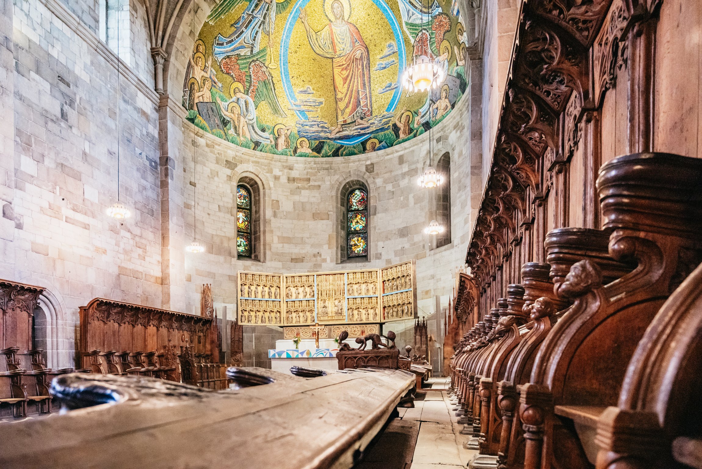 The apse mosaic and carved wooden choir stalls inside Lund Cathedral