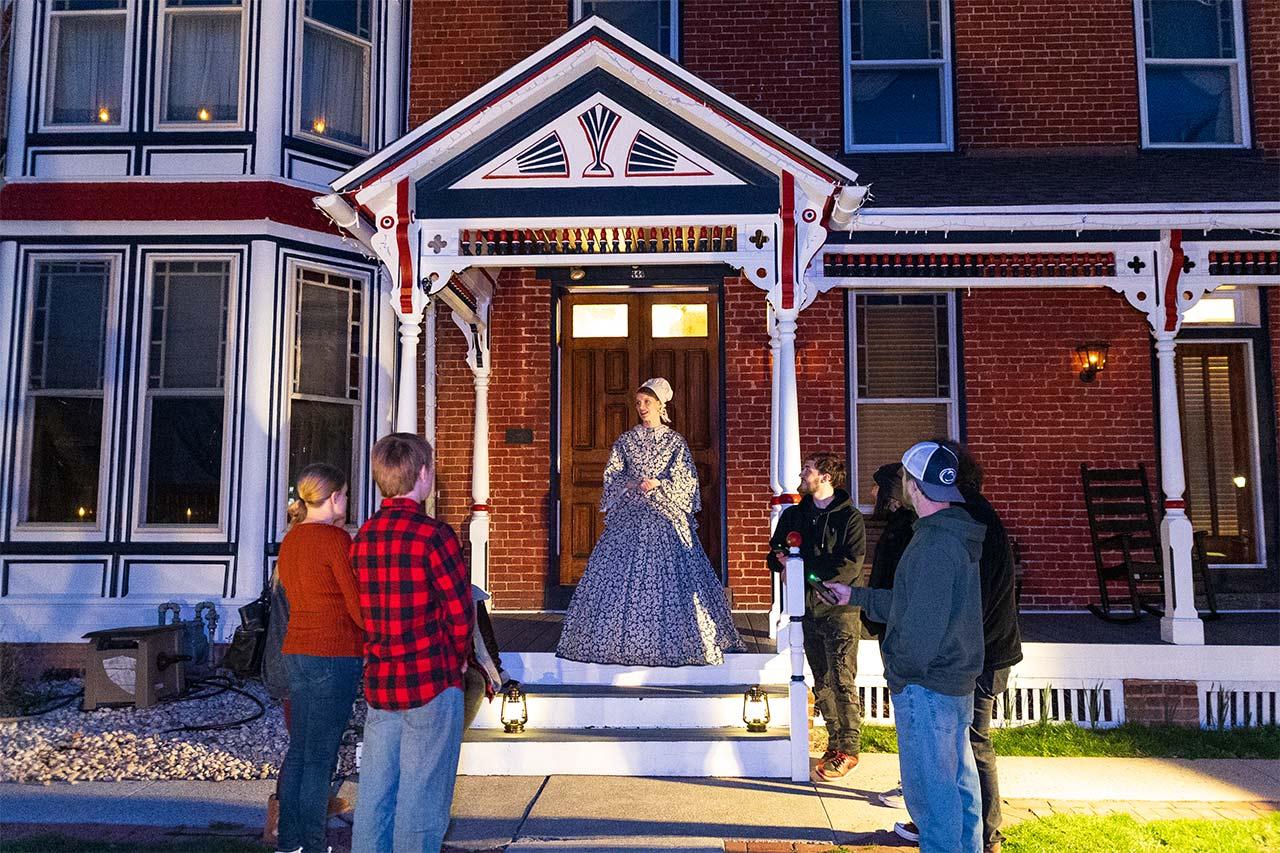 Gettysburg ghost tour group on historic Baltimore Street at night, haunted walking tour