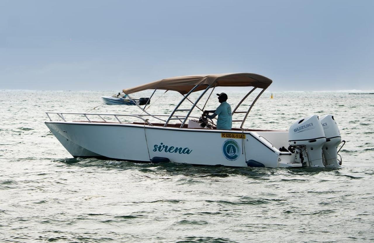 SirenaMoris speedboat on open water beneath a cloudy sky