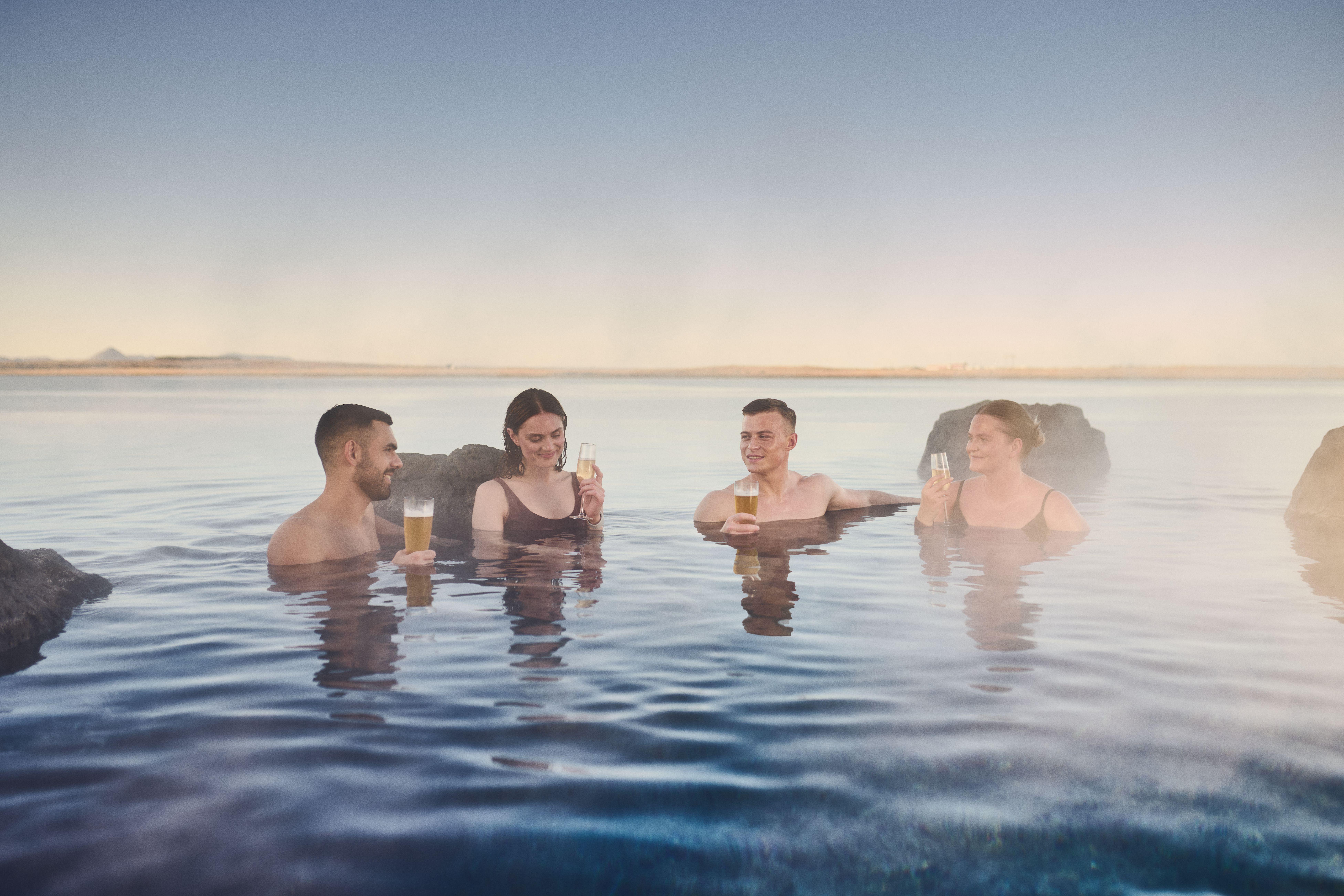 Visitors relaxing in the warm Sky Lagoon geothermal water during the 7-step Skjol ritual, Reykjavik