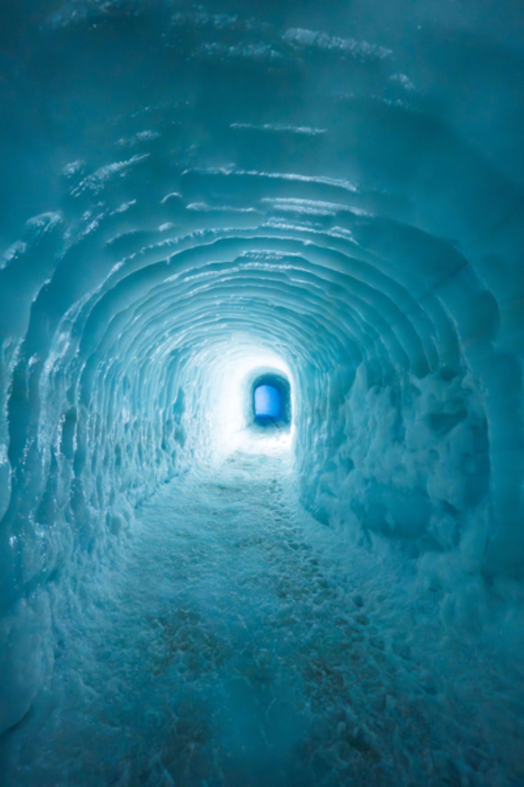 Visitors walking the lit galleries of the Langjökull ice cave tunnel