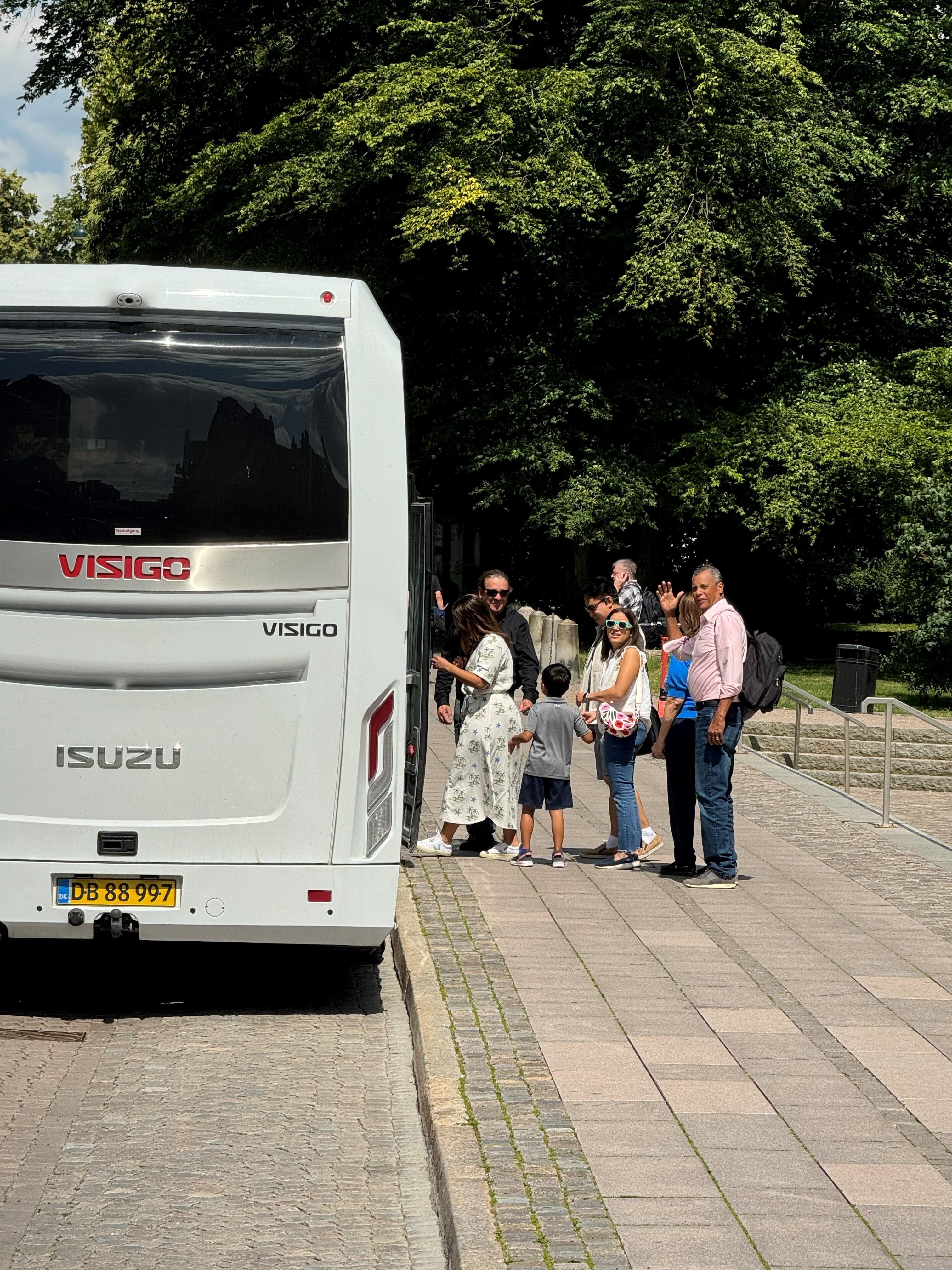 Travellers gathering beside the tour minibus