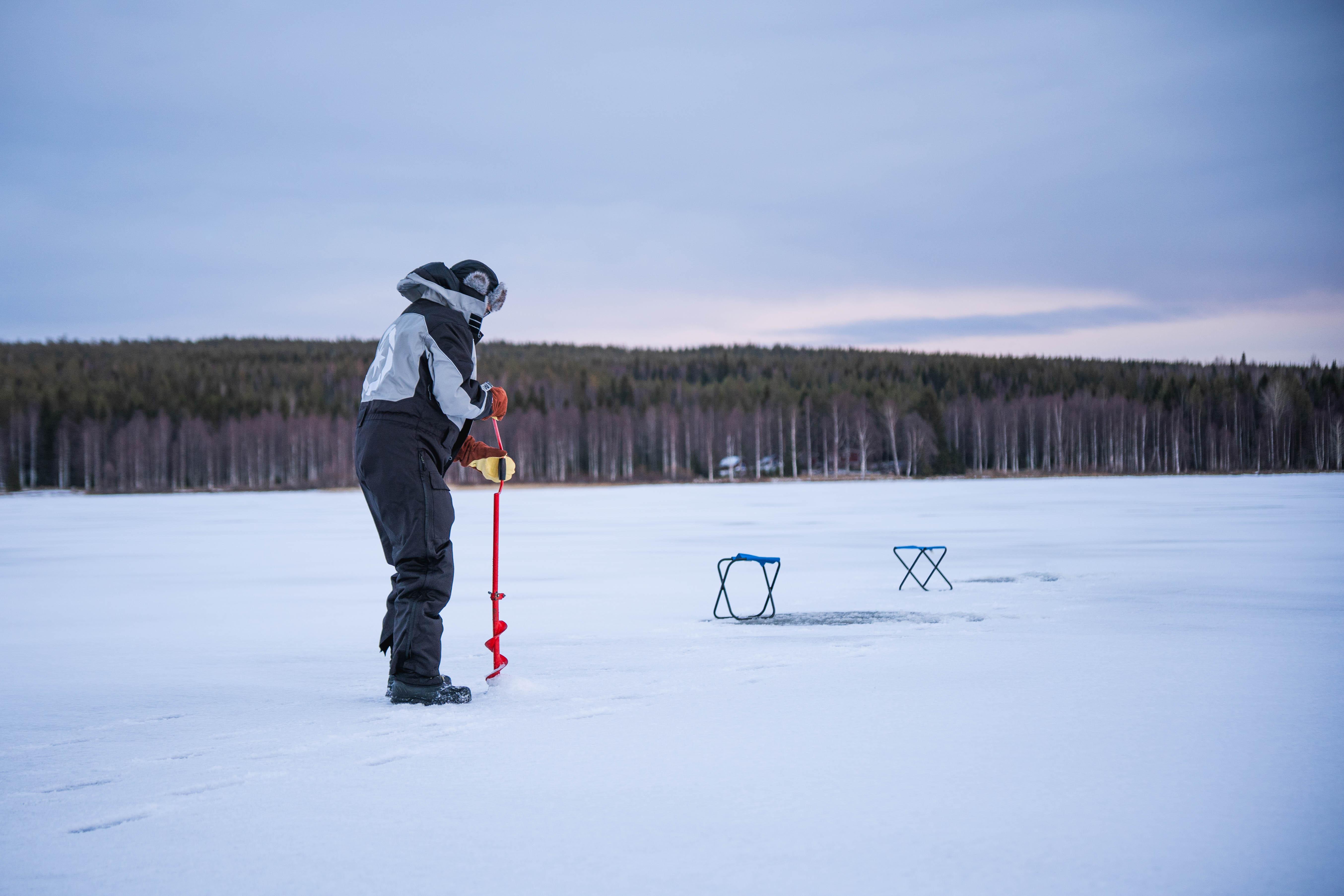 Rovaniemi Ice Fishing on a Frozen Lake with BBQ & Photos