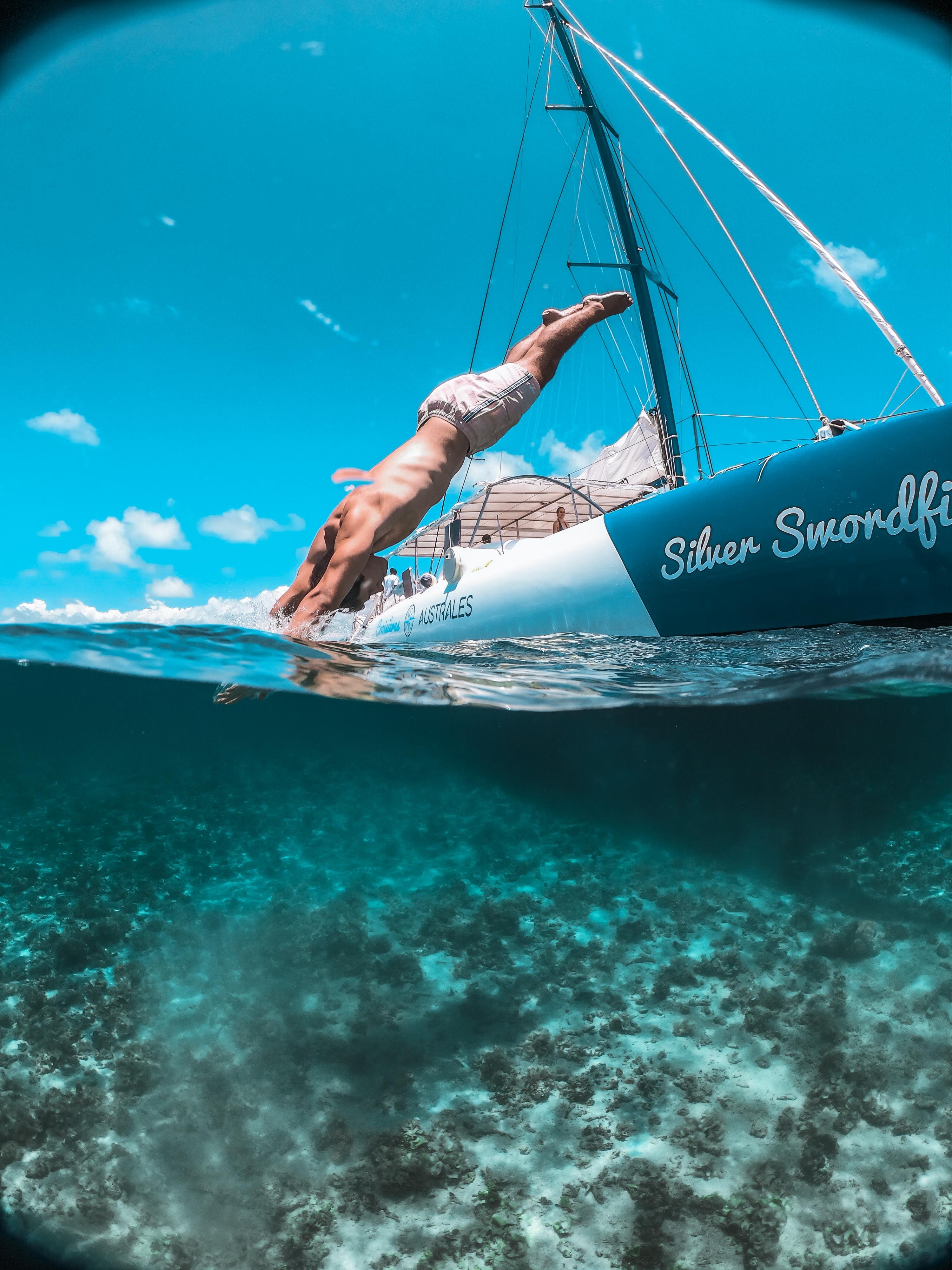 Guest diving from the Blue Safari catamaran