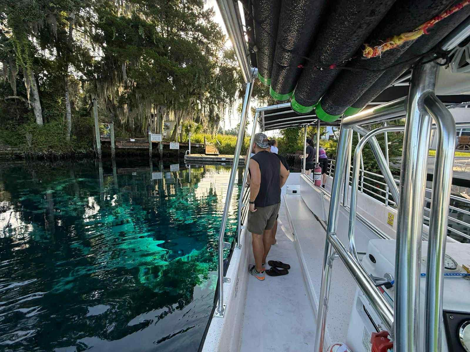 Passenger at a viewing boat rail watching the water