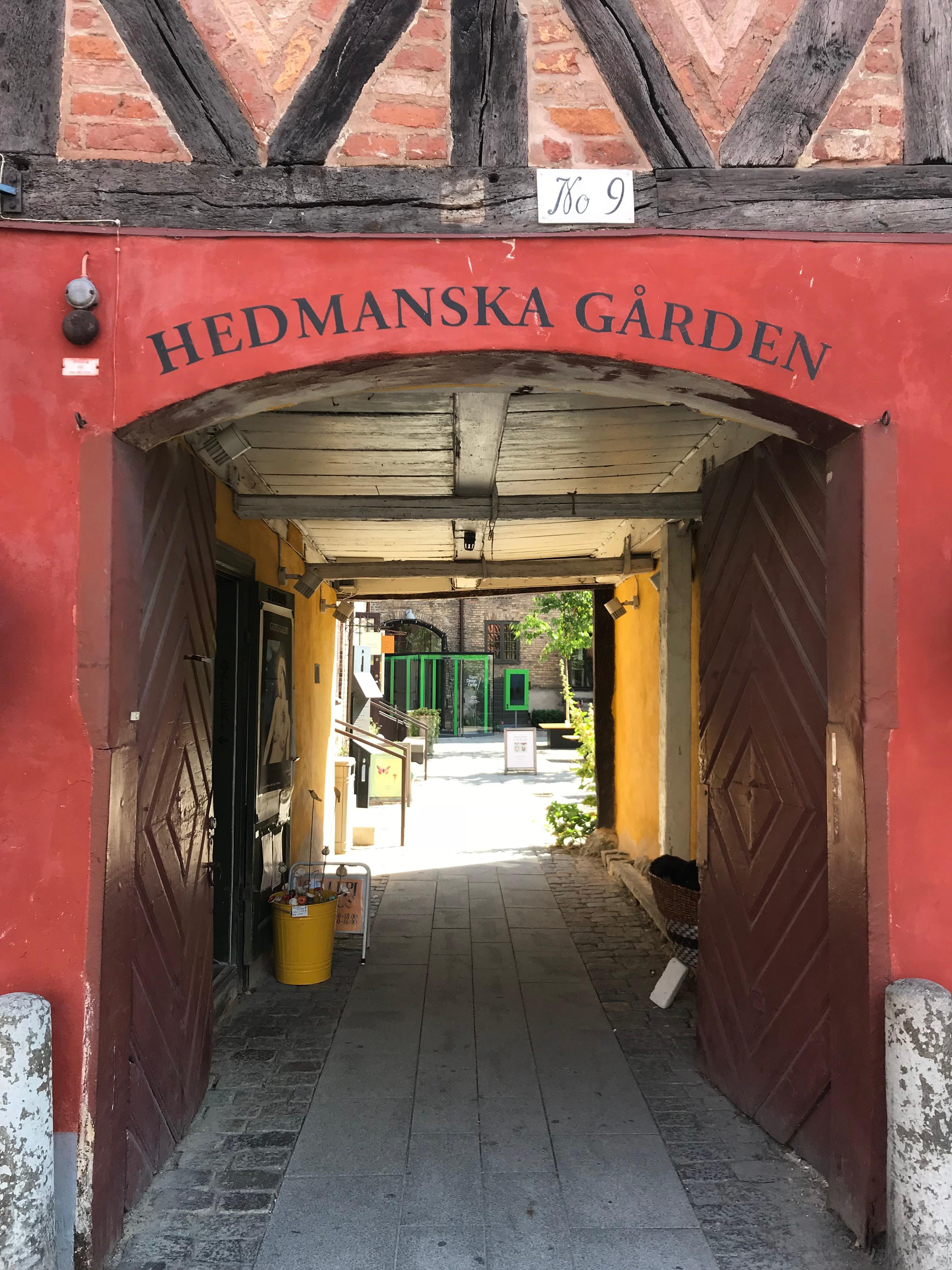 The red gateway of Hedmanska gården, a half-timbered courtyard in Malmö