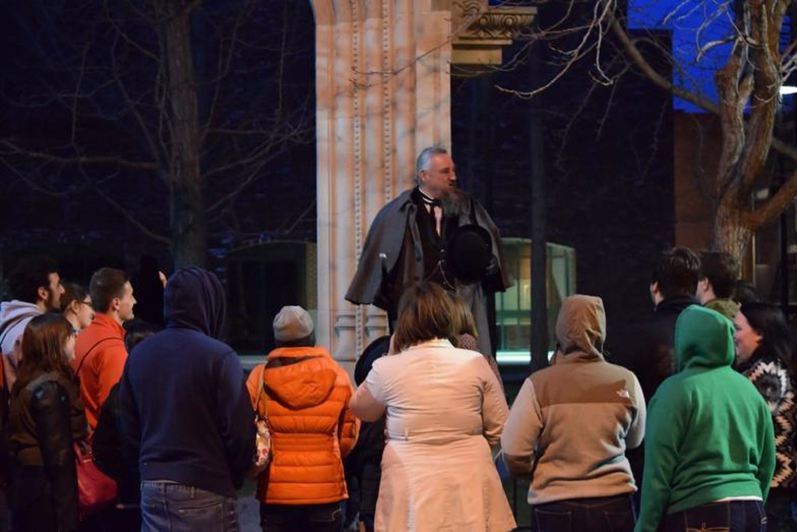 Salem night ghost tour group on a lantern-lit haunt and history walk after dark
