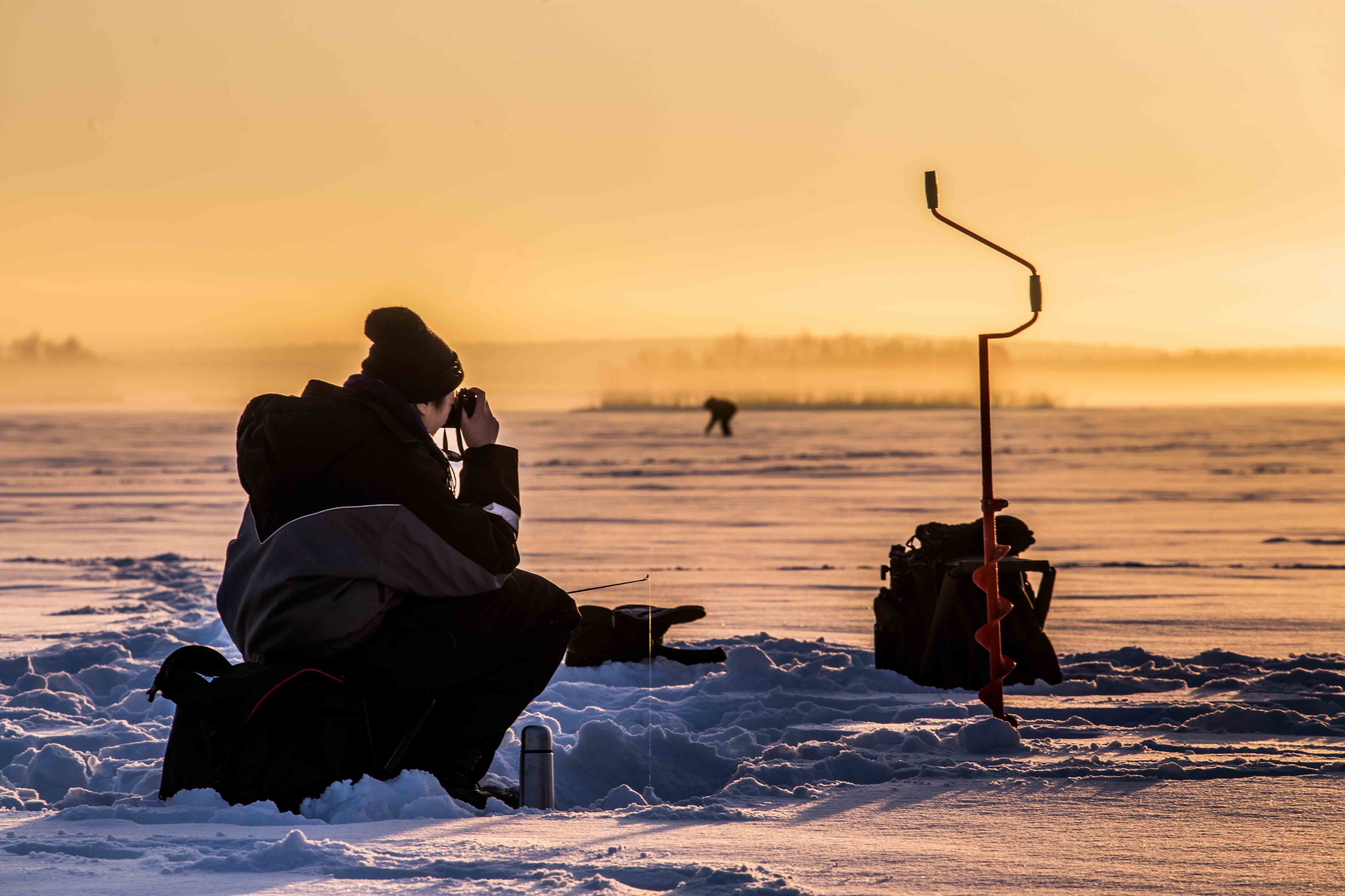Rovaniemi Ice Fishing on a Frozen Lake with BBQ & Photos