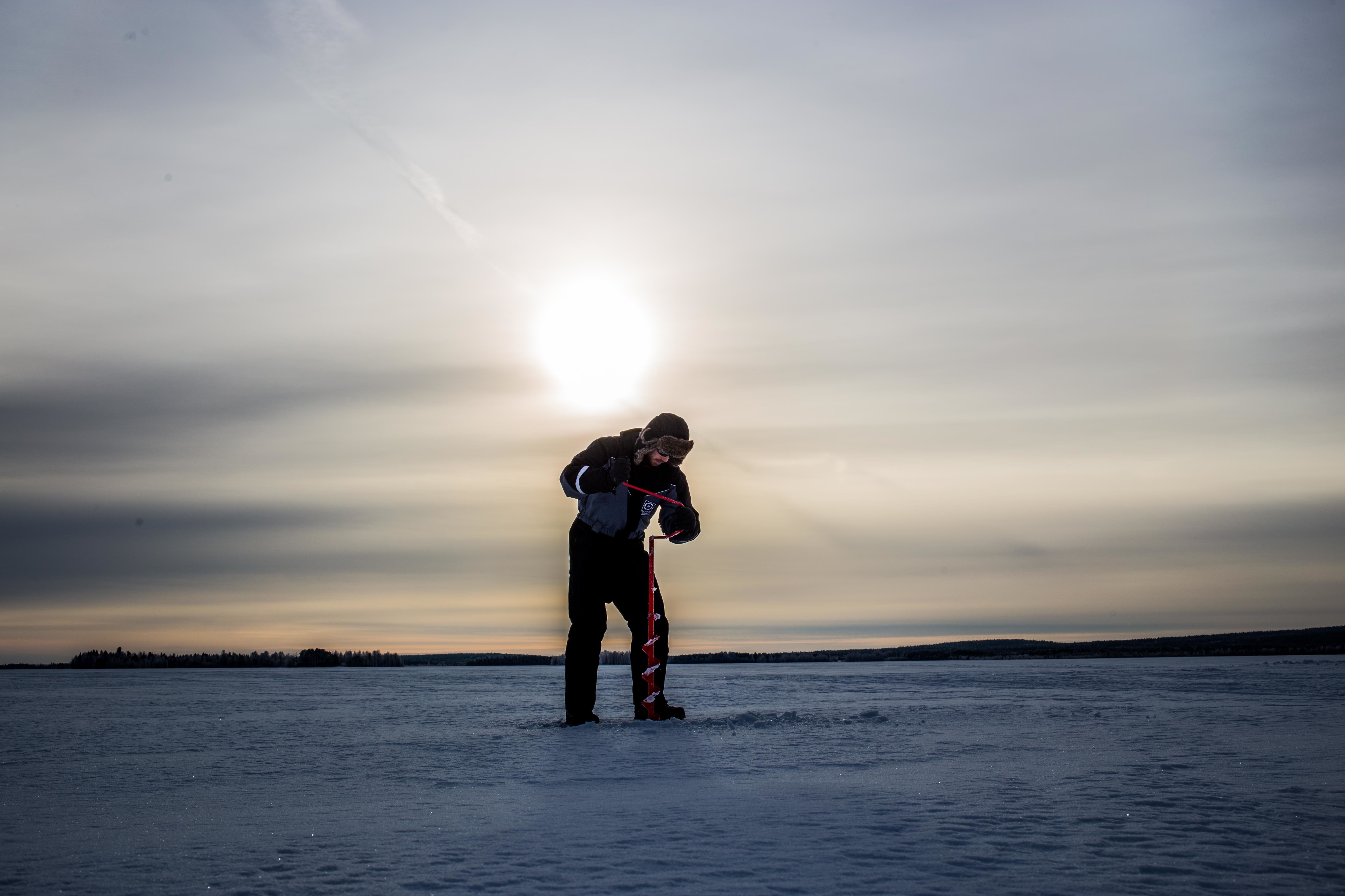 Rovaniemi Ice Fishing on a Frozen Lake with BBQ & Photos