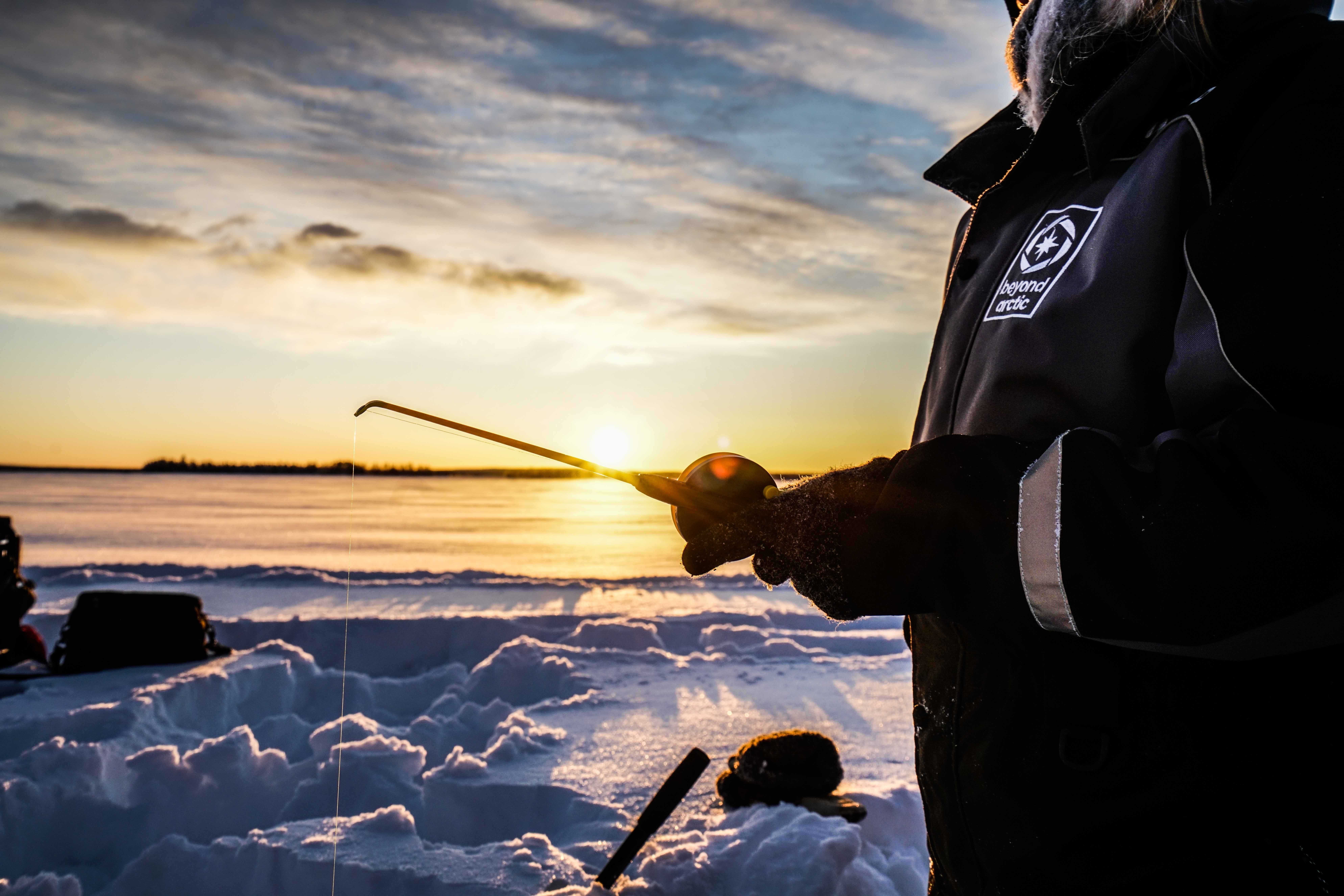 Rovaniemi Ice Fishing on a Frozen Lake with BBQ & Photos
