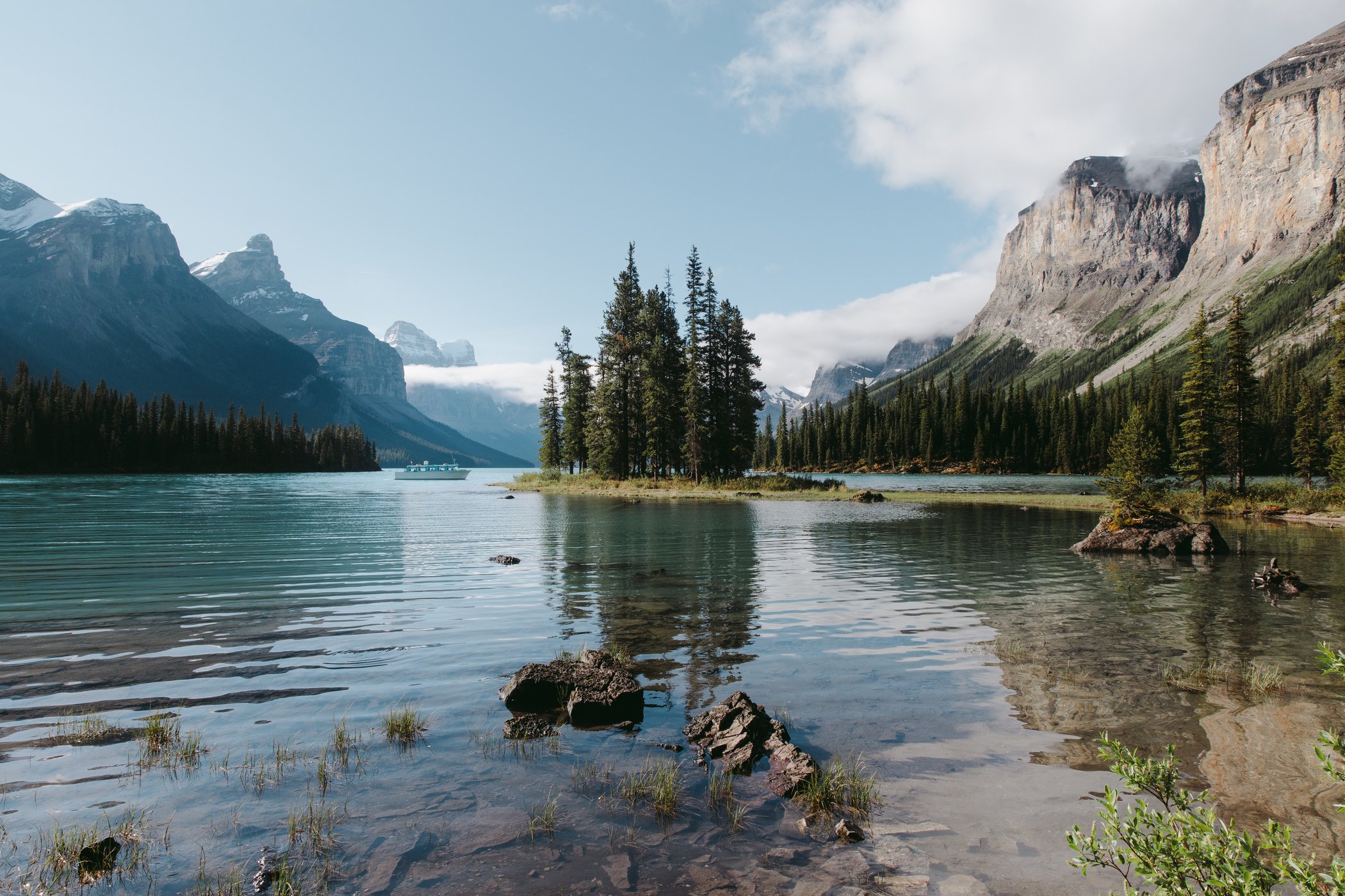 Calm morning reflections on glacier-fed Maligne Lake during the Spirit Island cruise, Jasper