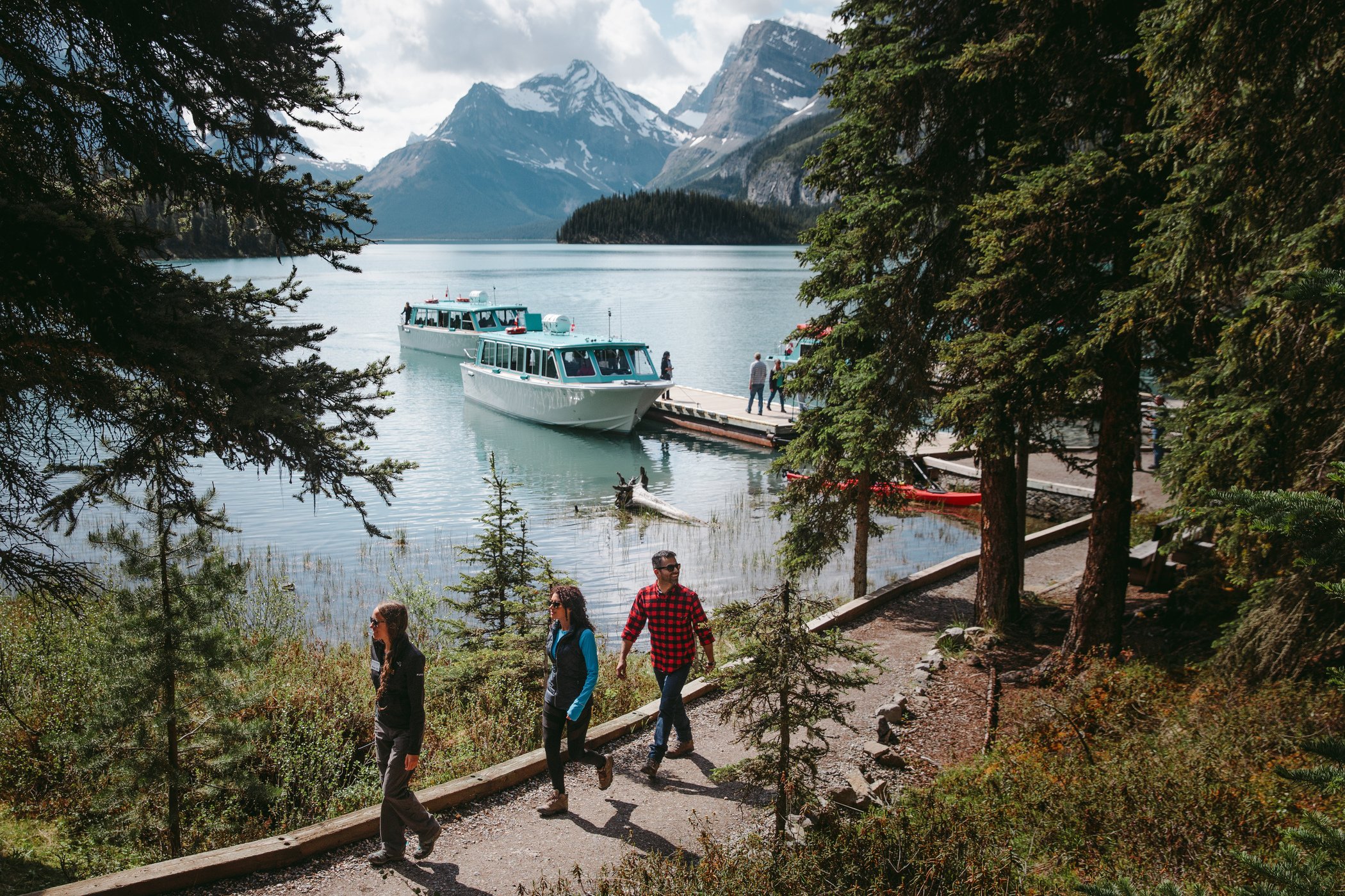 Maligne Lake scenic cruise across glacier-fed water toward Spirit Island, Jasper