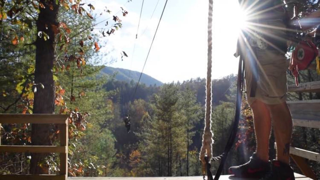 Guide fitting gear for a Sevierville extreme mountain zipline adventure
