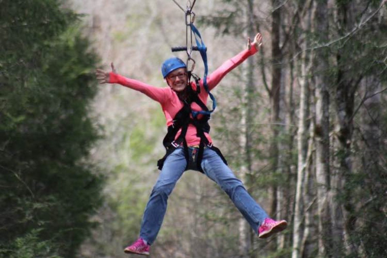 Zip line crossing above a waterfall on a Smoky Mountain canopy tour