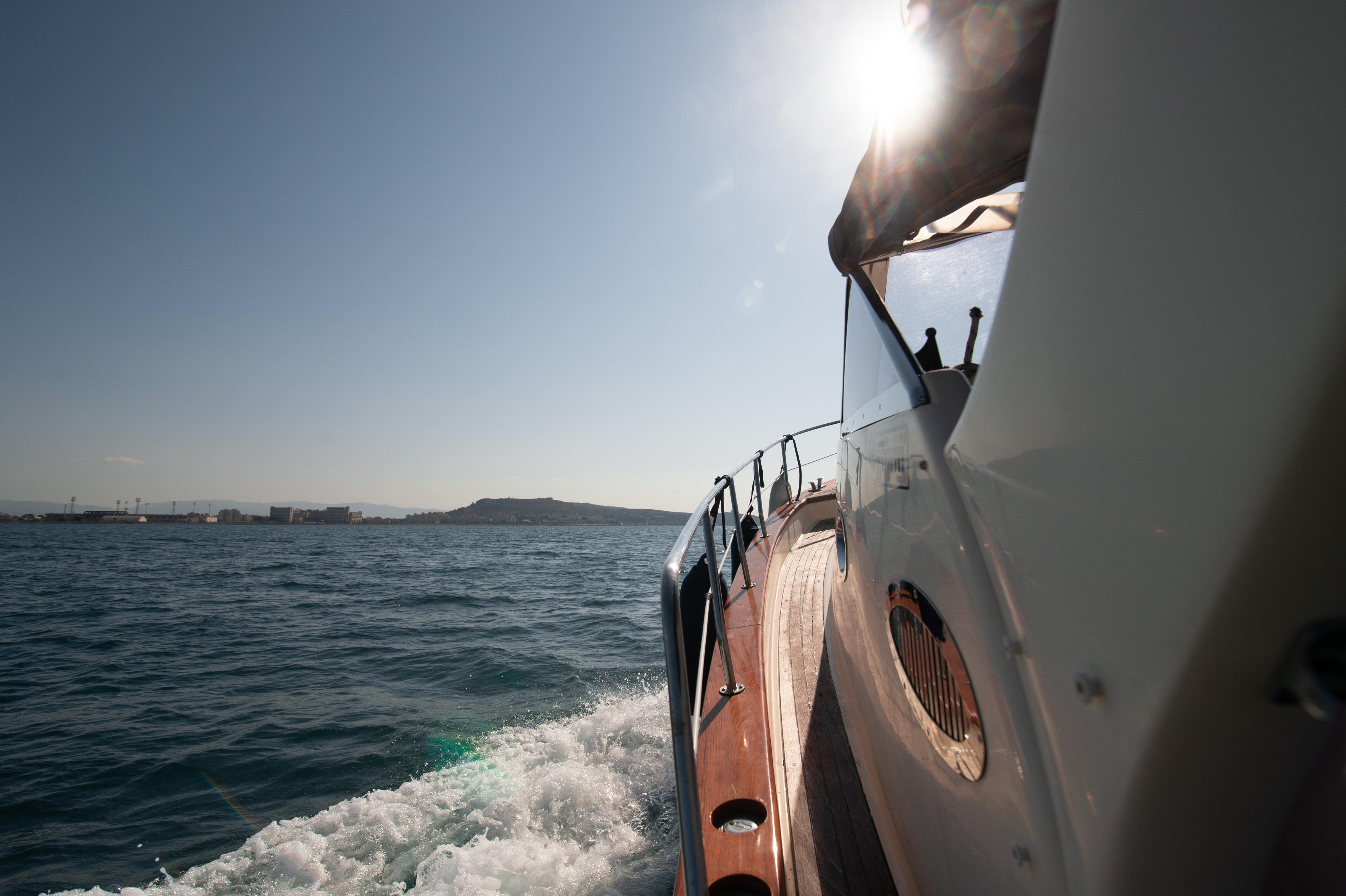 Private Gozzo boat charter exploring secret coves in the Gulf of Cagliari, Sardinia