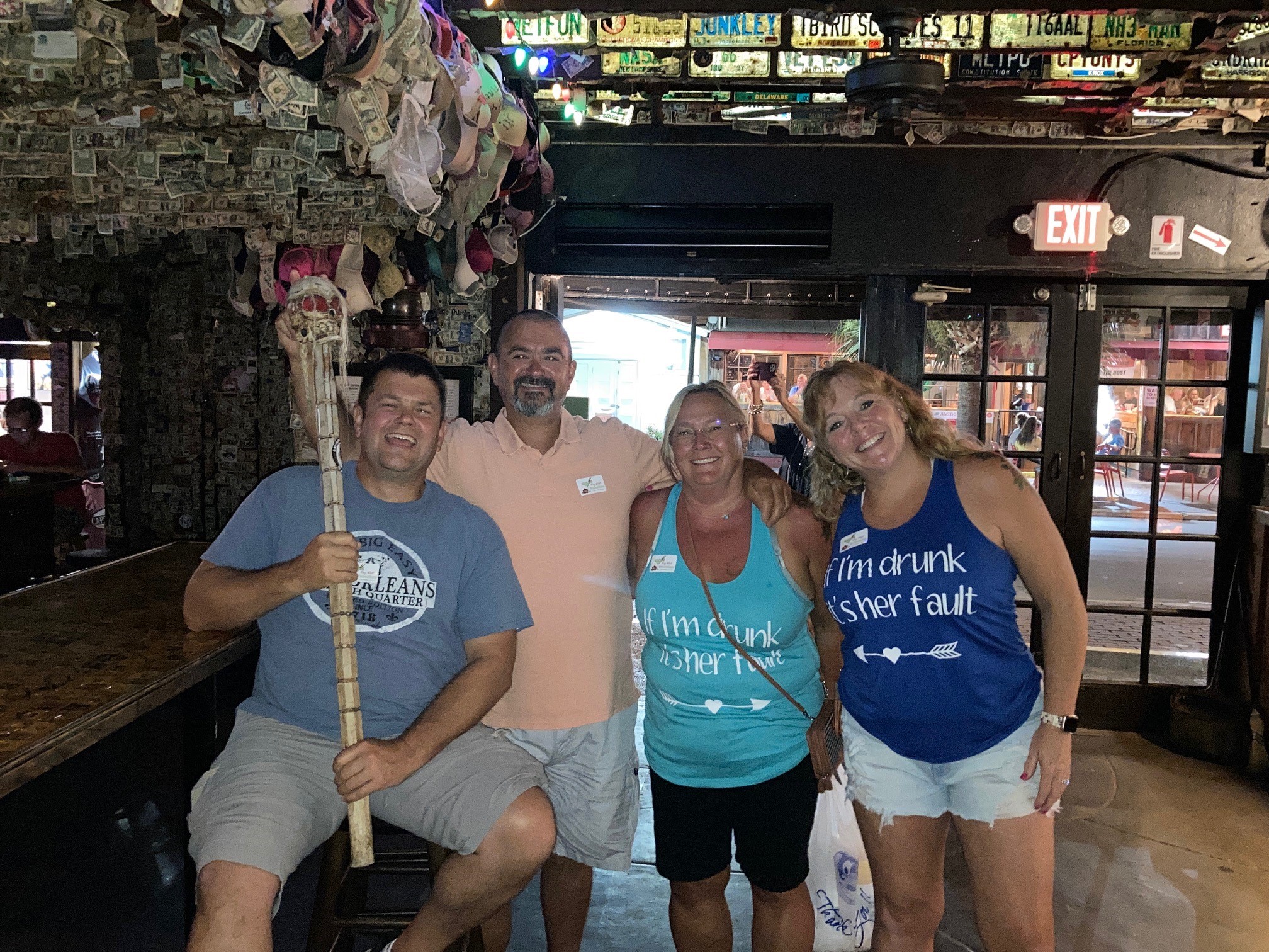 A guided haunted pub crawl group outside a historic Key West bar