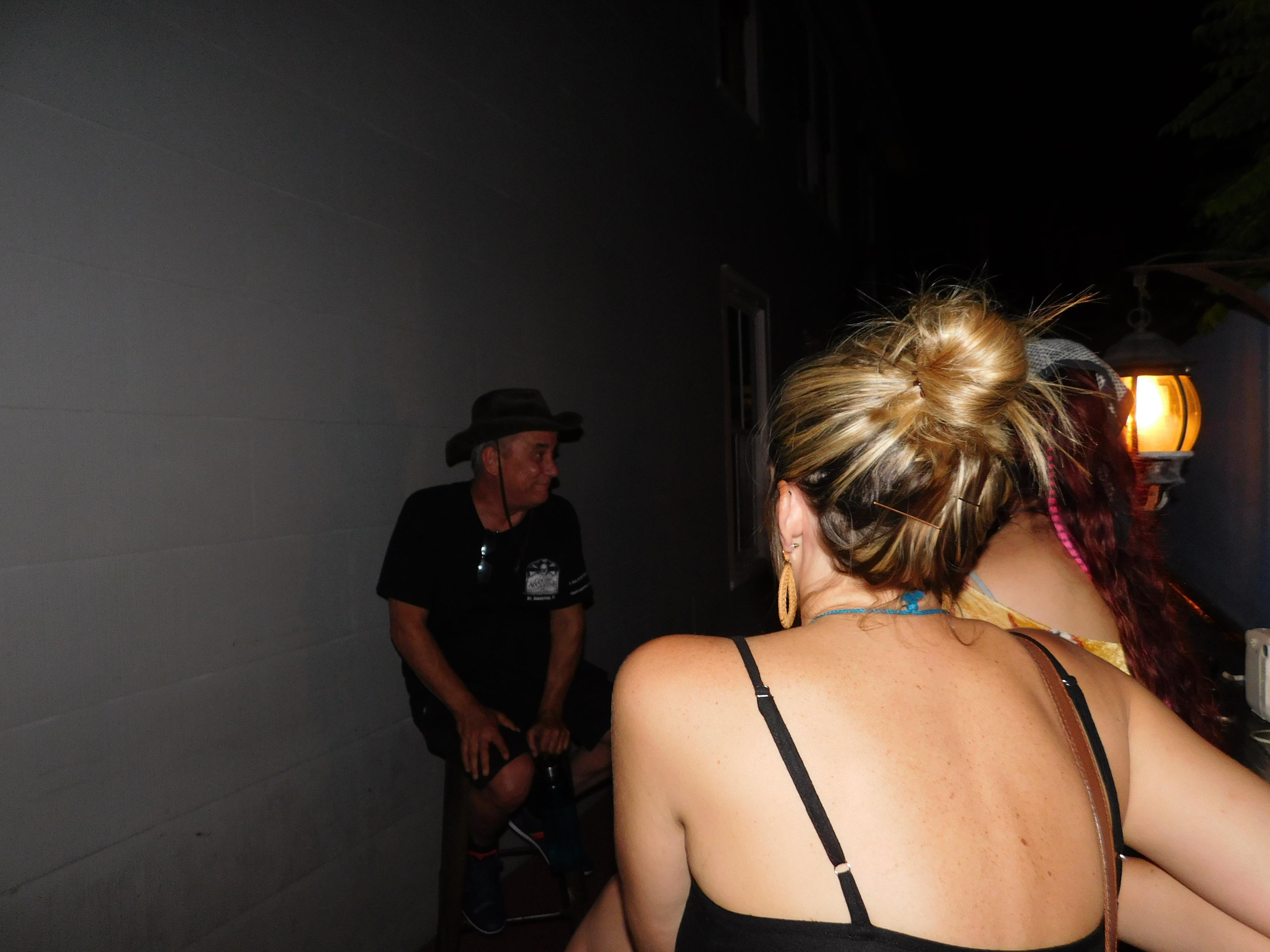 Ghost tour guide sharing haunted history at a St Augustine pub — eerie watering hole on the pub crawl route