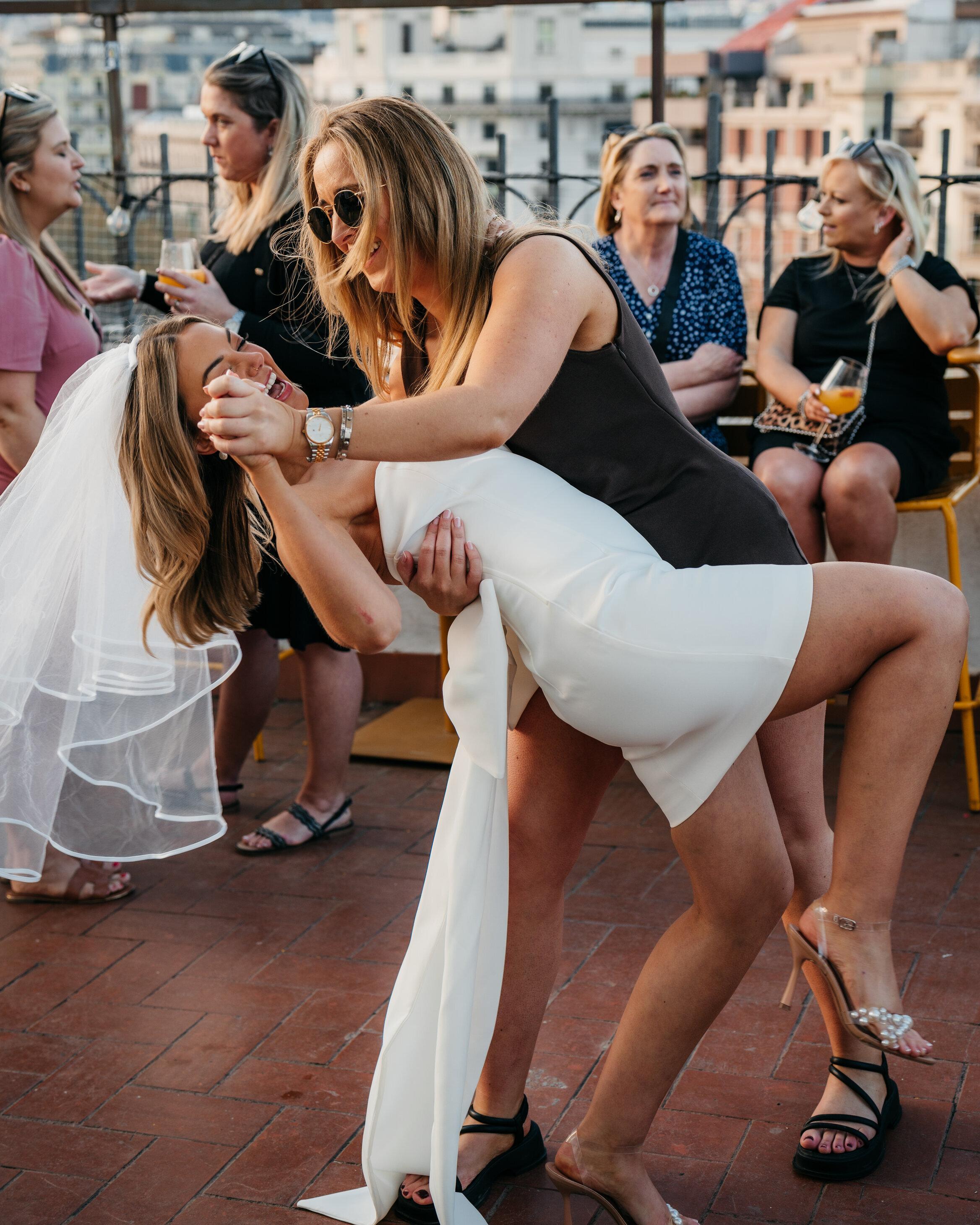 Barcelona rooftop salsa class — beginners learning the basic step at sunset with the Eixample skyline behind