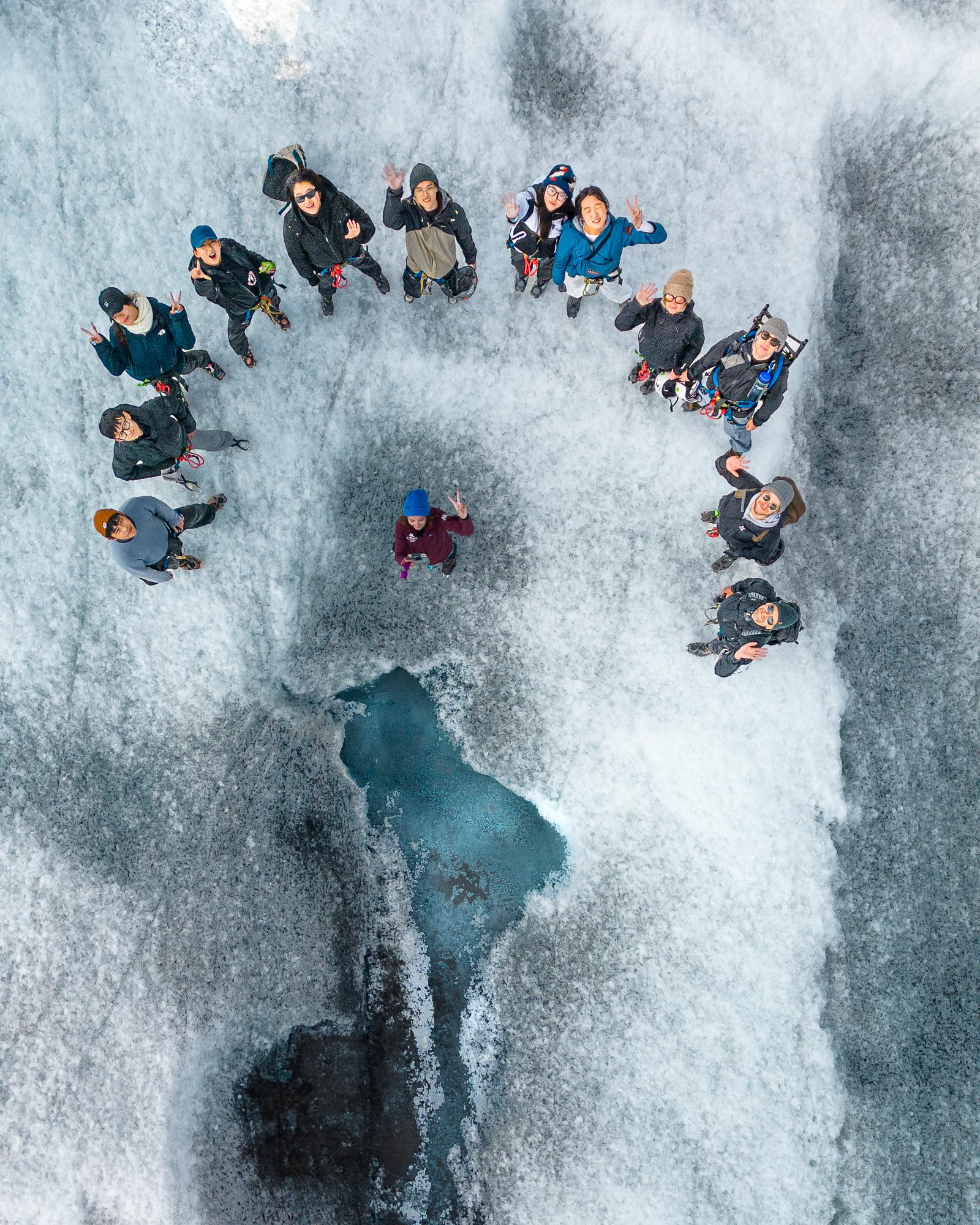 Guide demonstrating crampon technique on glacial ice