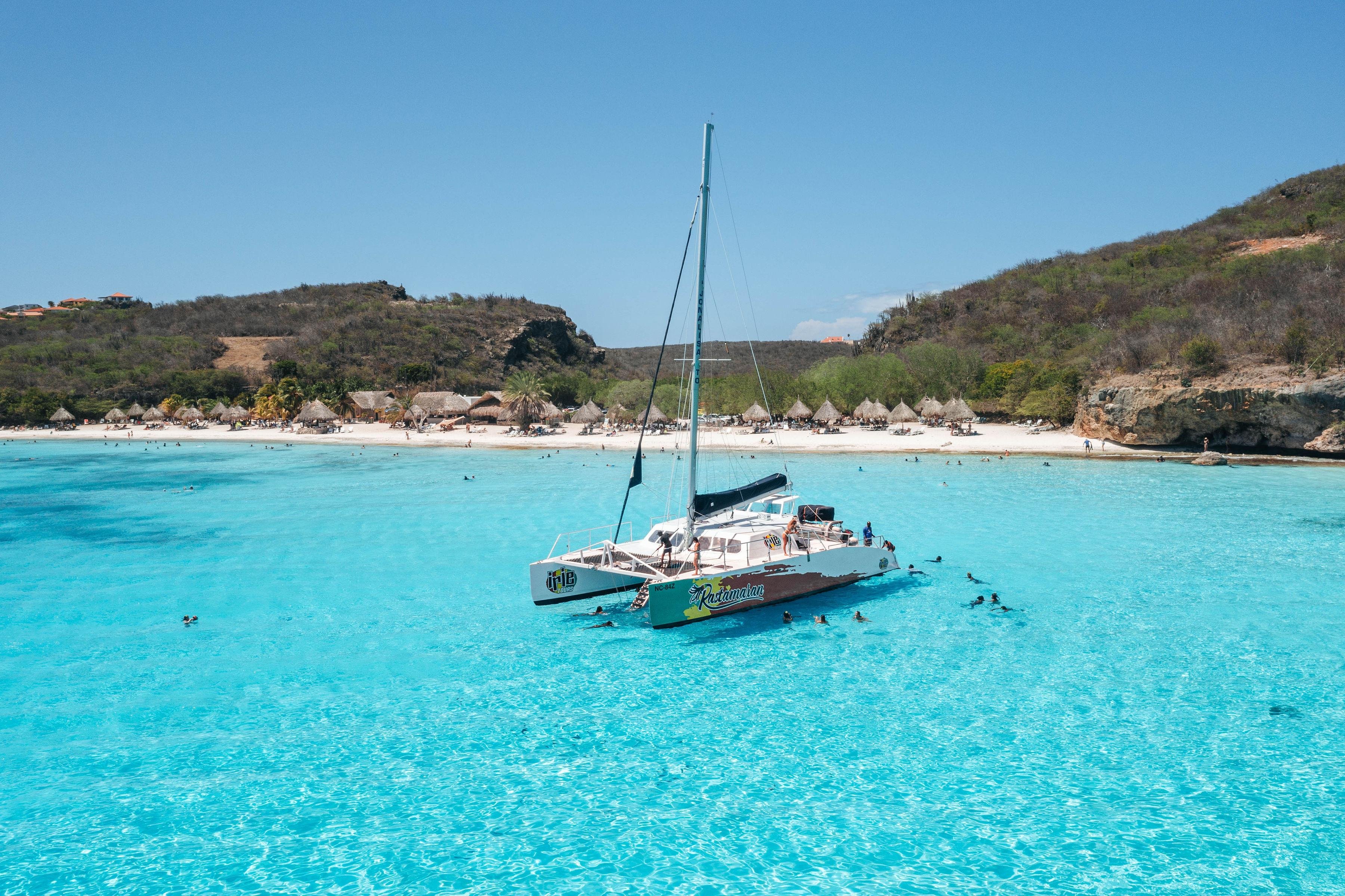 West Coast Catamaran Adventure with Blue Cave & Beach BBQ