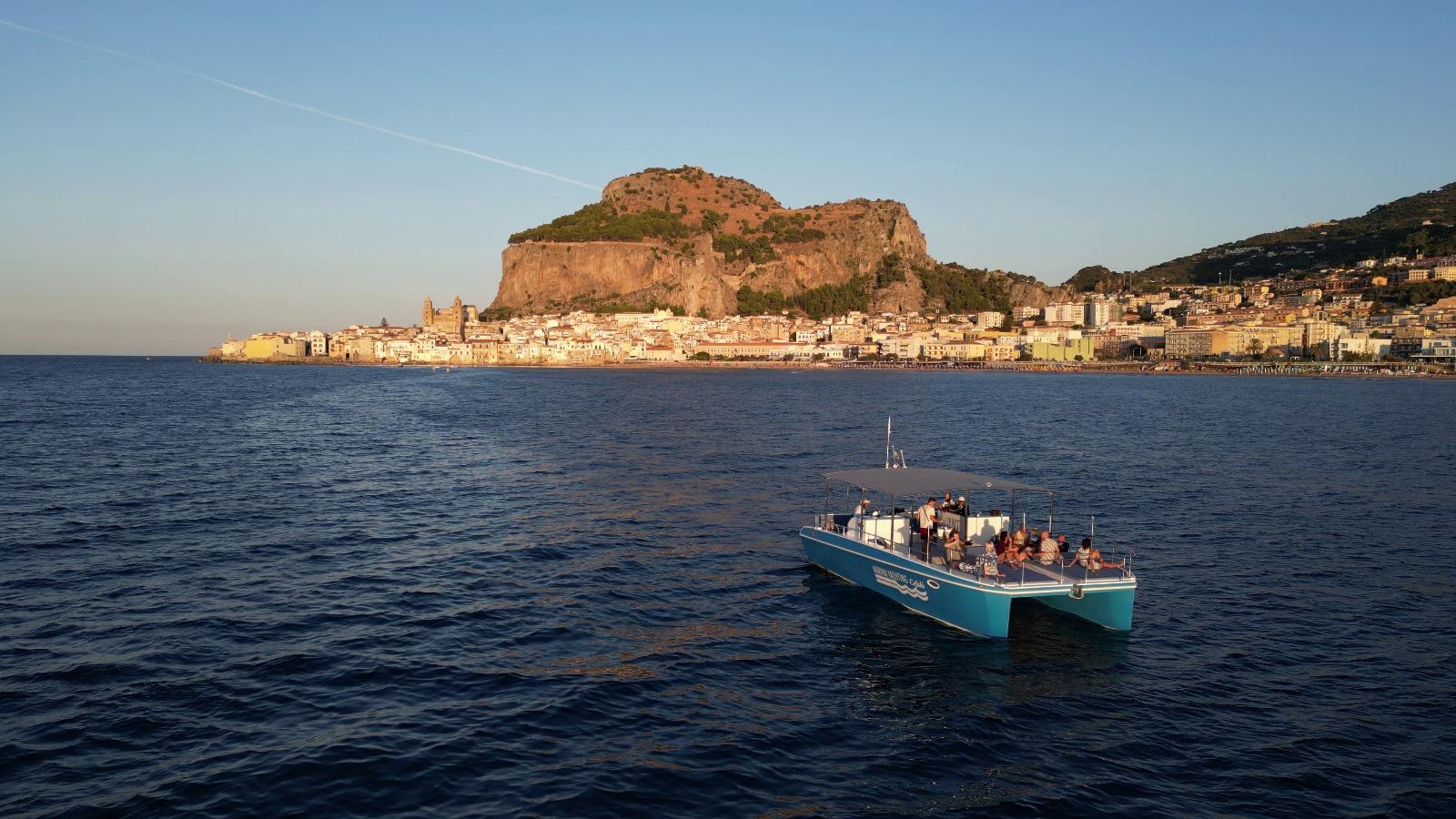 Cefalù coast to coast boat tour — catamaran on the Sicilian coast — image 1