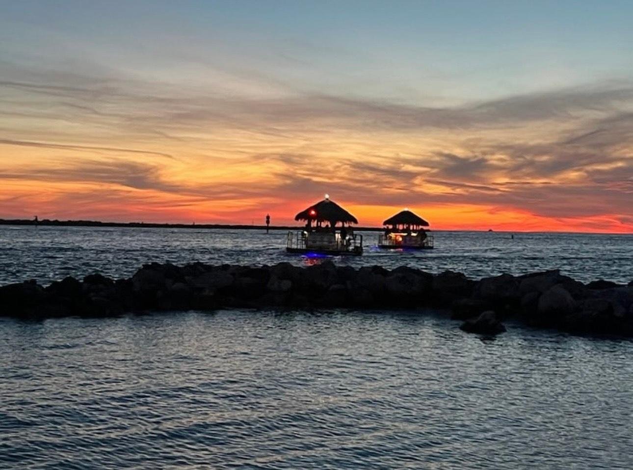 Sunset Tiki Cruise, guests looking across Gulf water
