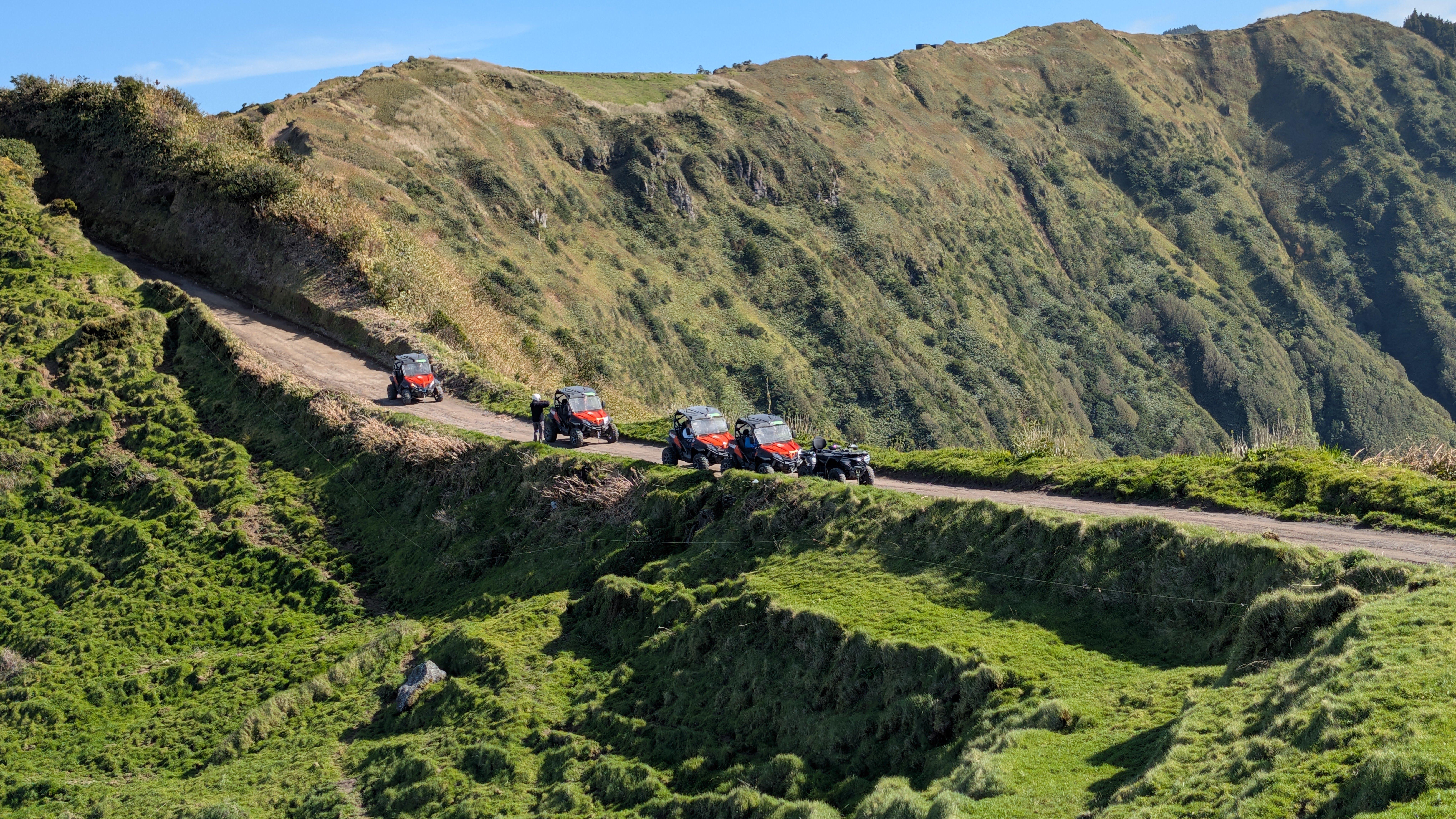 Buggies following a narrow dirt track through the caldera landscape