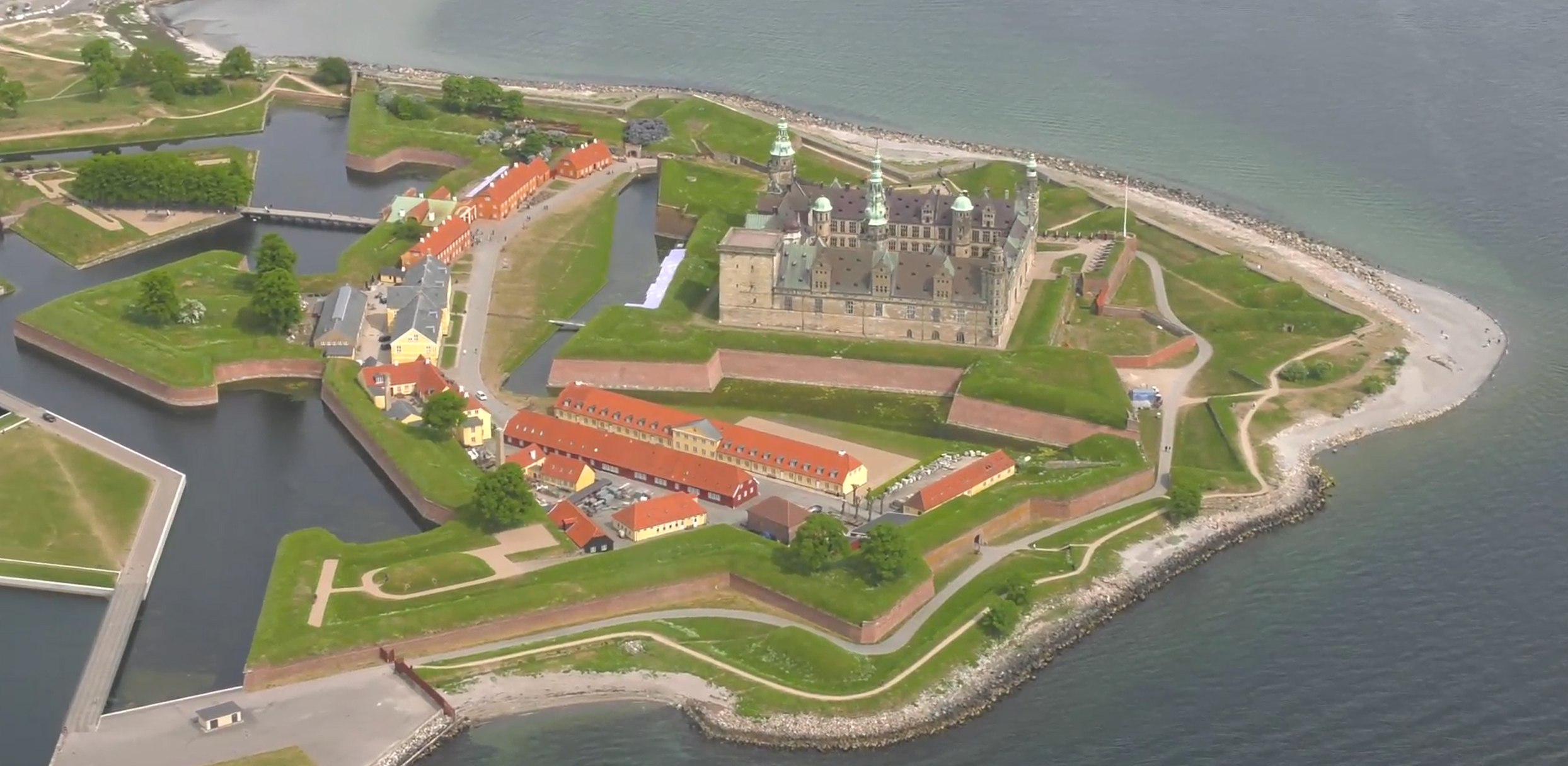 Kronborg from the air, its star-shaped ramparts and moats on the point in the Sound