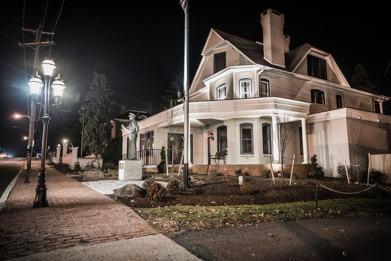 US Ghost Adventures guide with lantern leading Gettysburg ghost tour through historic streets