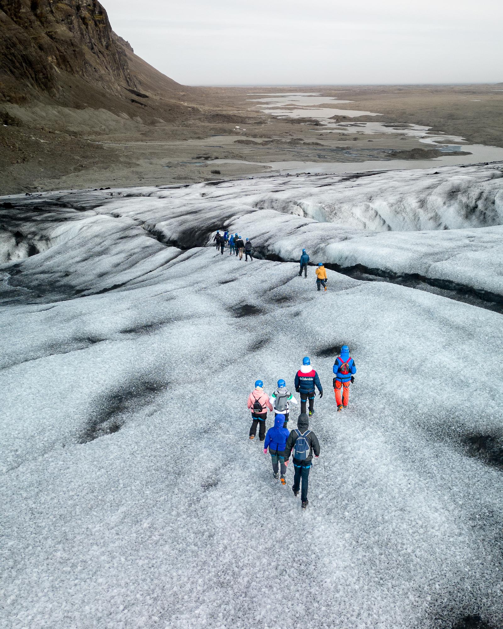 Hikers on a Vatnajökull glacier hike with the ice cap on the horizon