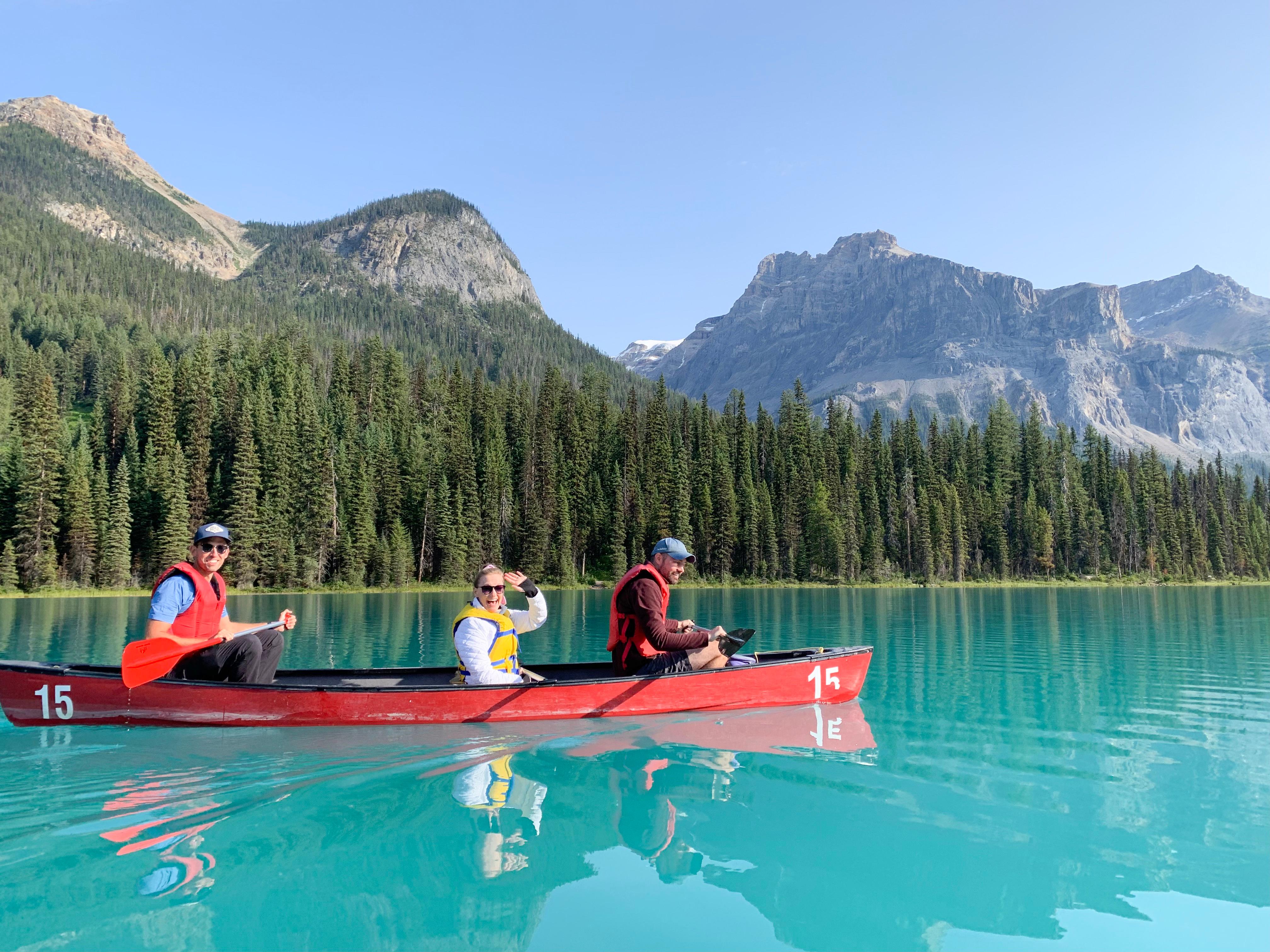 Lake Louise red canoe on glacier-fed turquoise water on a Banff canoe tour