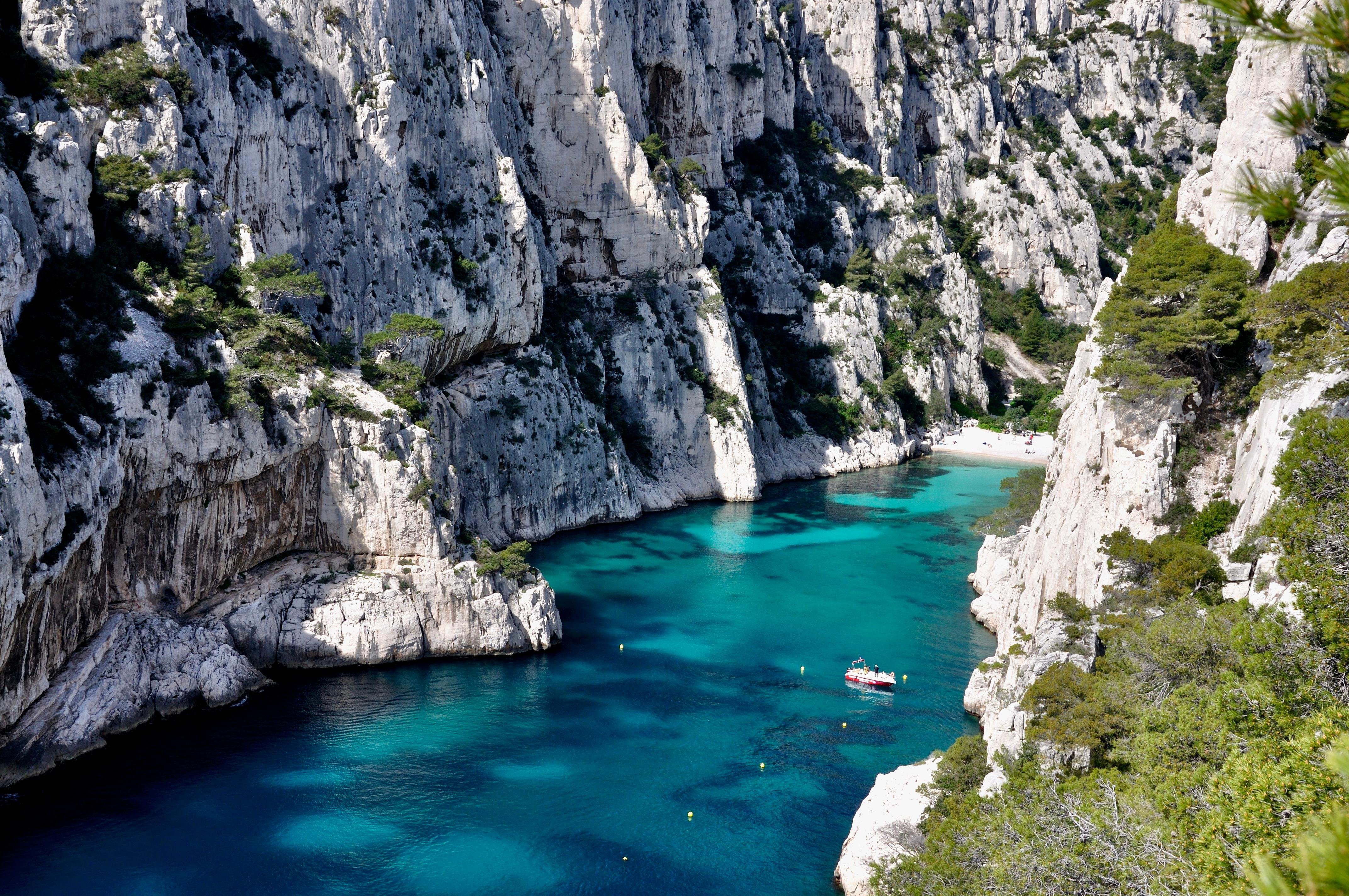 Calanques boat tour from Marseille — sheer white limestone walls rising from the blue Mediterranean sea