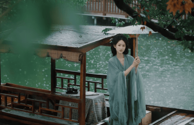 Woman in flowing Hanfu beside the water in Wuzhen ancient town