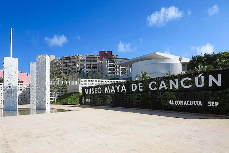 Entrada al Museo Maya de Cancún con cielo azul.