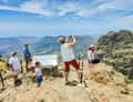 Family at viewpoint photographing valley
