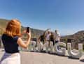 Woman photographing La Orotava letters sign