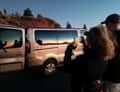 Minibus and guests at sunset