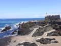 Lava rock pools and seaside fortress