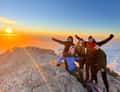 Group on summit at sunrise