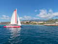 Red catamaran off coastal resort