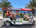 Tuk-tuk with tourists on seafront