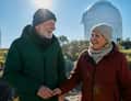 Older couple smiling, observatory dome behind