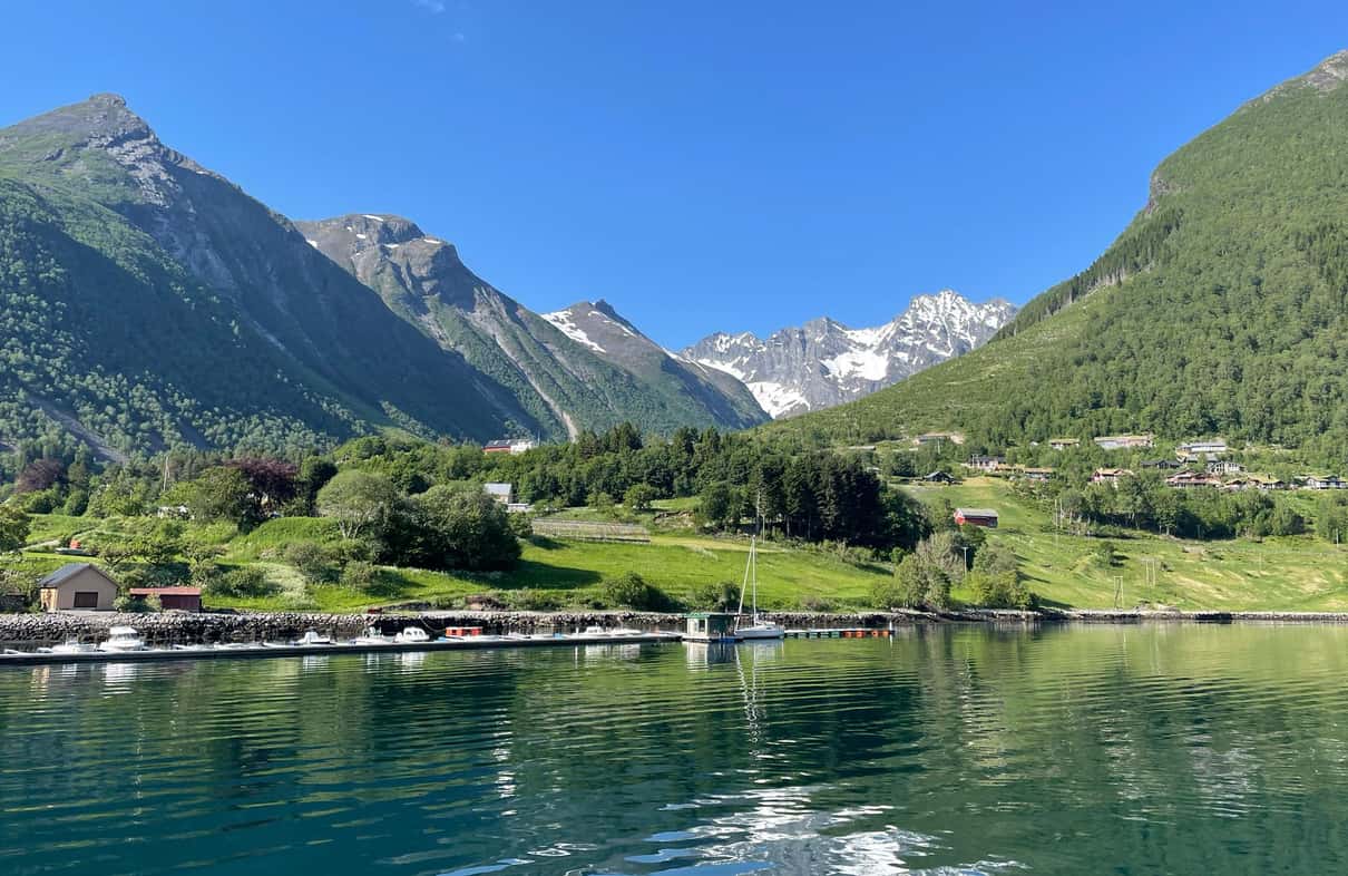 Classic fjord liner cruising through Hjørundfjord beneath the steep peaks of the Sunnmøre Alps in Norway