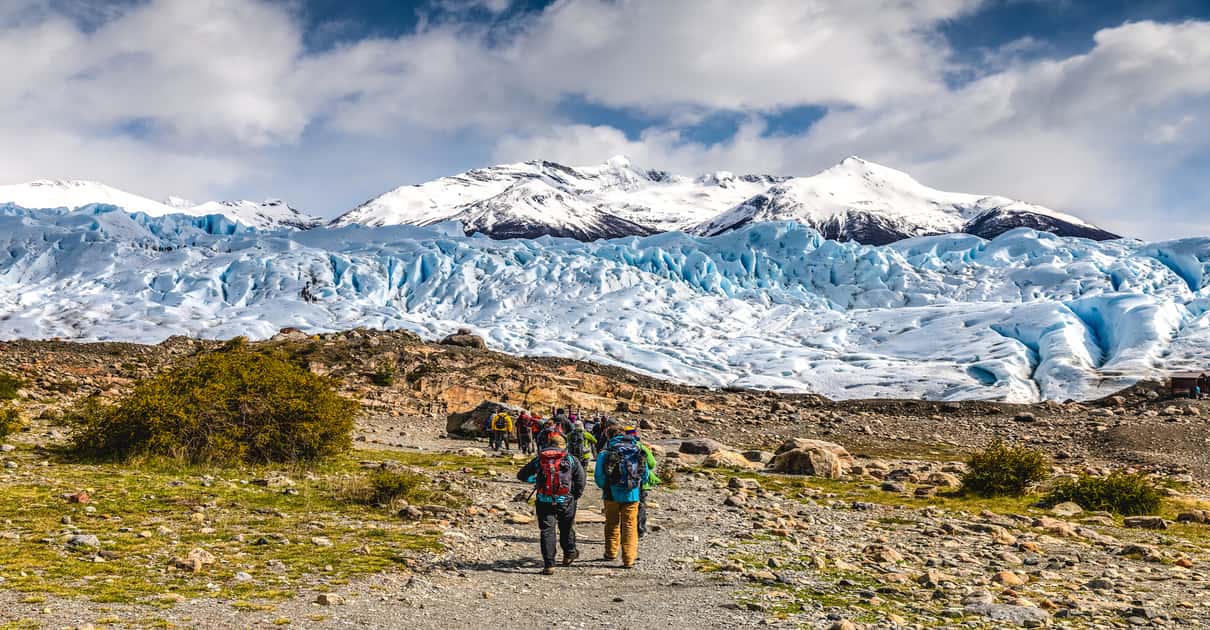 Guided group crossing the crevassed surface of Perito Moreno Glacier on a trekking tour