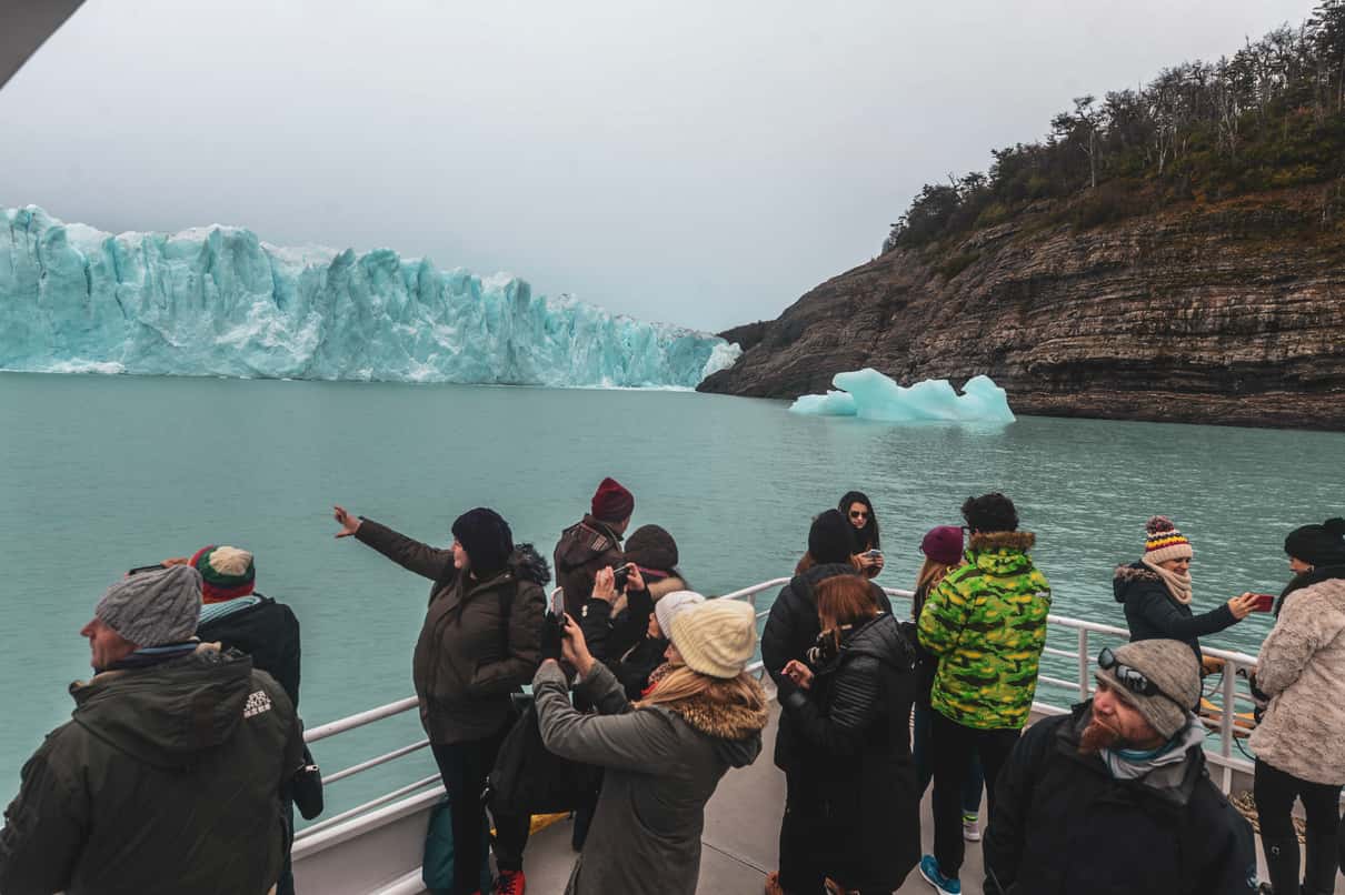 Visitors on the boardwalk viewpoints facing the ice wall of Perito Moreno Glacier