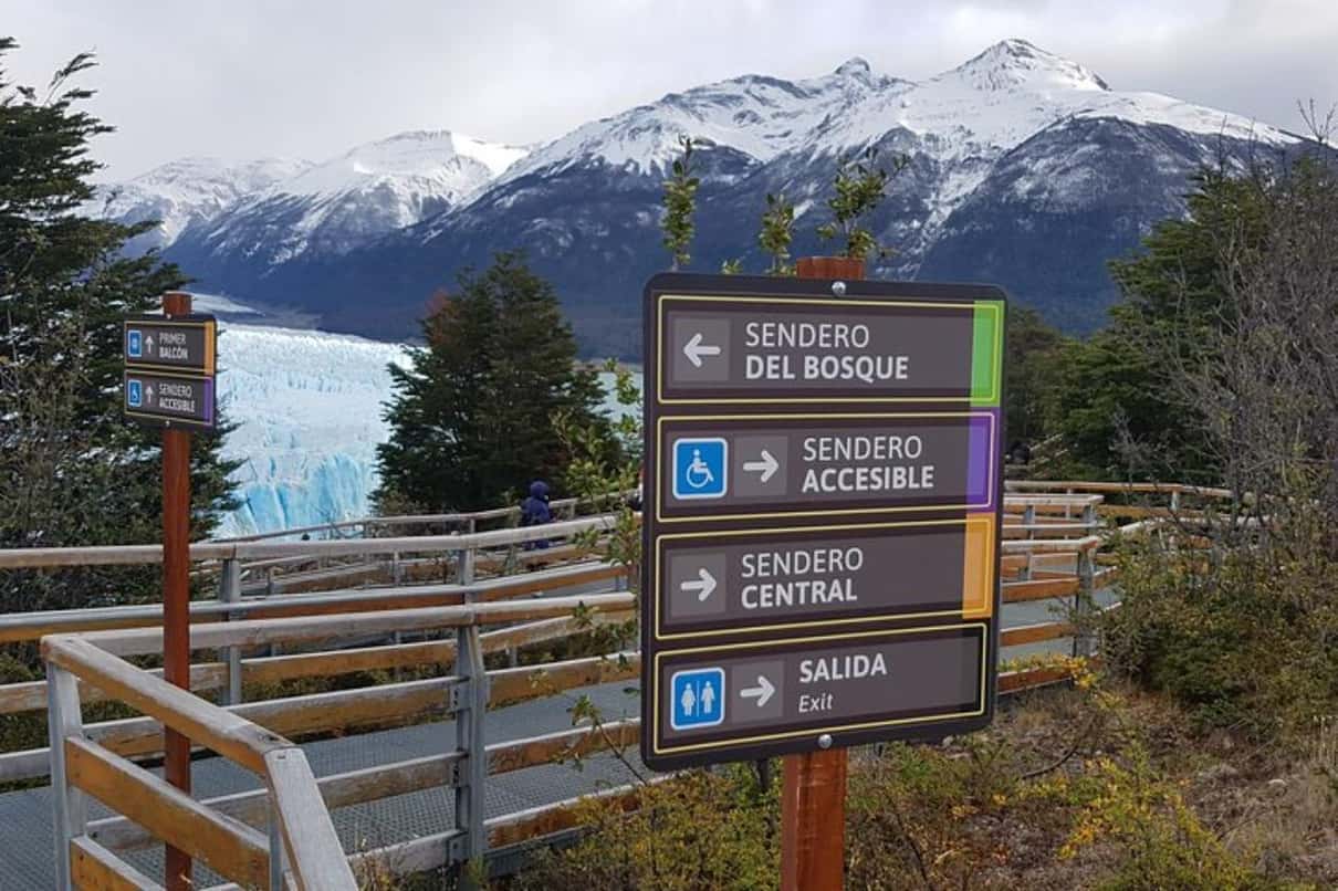 Visitors on the steel boardwalks facing the blue seracs of Perito Moreno Glacier