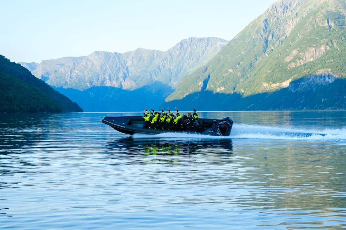 RIB safari boat speeding across Hjørundfjord below the Sunnmøre Alps near Ålesund